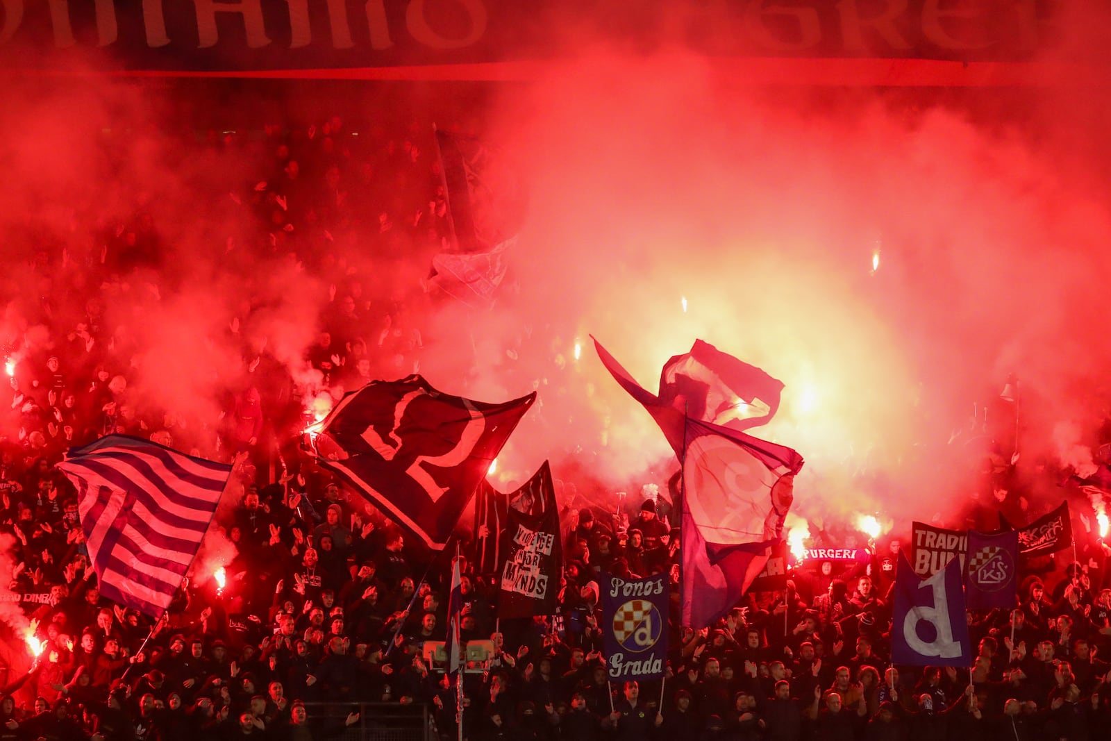 Supporters light flares during the Champions League soccer match between Dinamo Zagreb and Dortmund at Maksimir Stadium, in Zagreb, Croatia, Thursday, Nov. 28, 2024. (AP Photo)