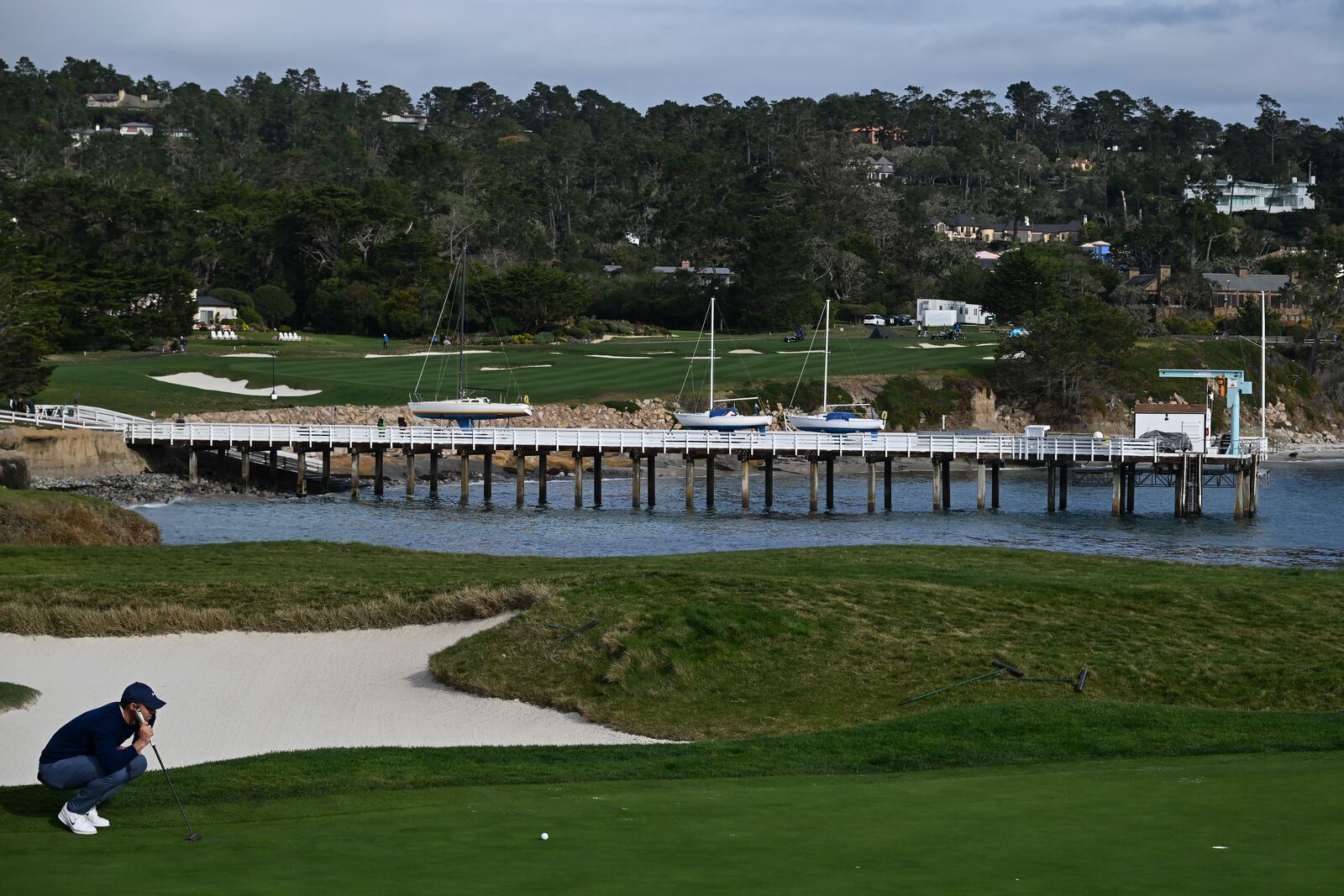 Rory McIlroy, of Northern Ireland, lines his putt on the 17th green at Pebble Beach Golf Links during the final round of the AT&T Pebble Beach Pro-Am golf tournament, Sunday, Feb. 2, 2025, in Pebble Beach, Calif. (AP Photo/Nic Coury)