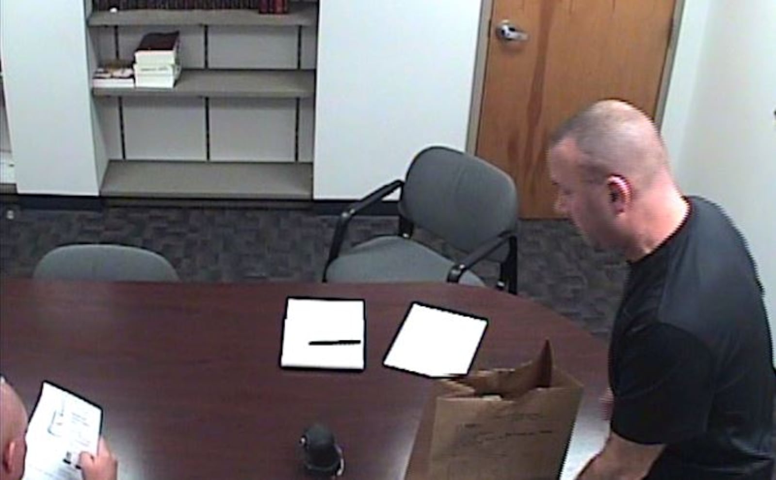 Lt. Jason Moore, with the Miami County Sheriff's Office, interviews the county's former IT director Matt Watkins. CONTRIBUTED