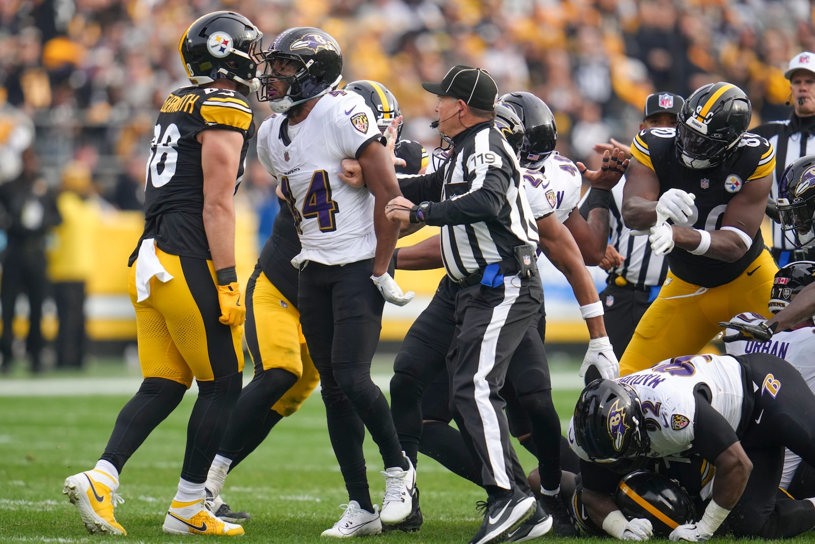 Pittsburgh Steelers tight end Pat Freiermuth, left, and Baltimore Ravens cornerback Marlon Humphrey argue as back judge Greg Wilson (119) tries to intervene during the first half of an NFL football game, Sunday, Nov. 17, 2024, in Pittsburgh. (AP Photo/Gene J. Puskar)