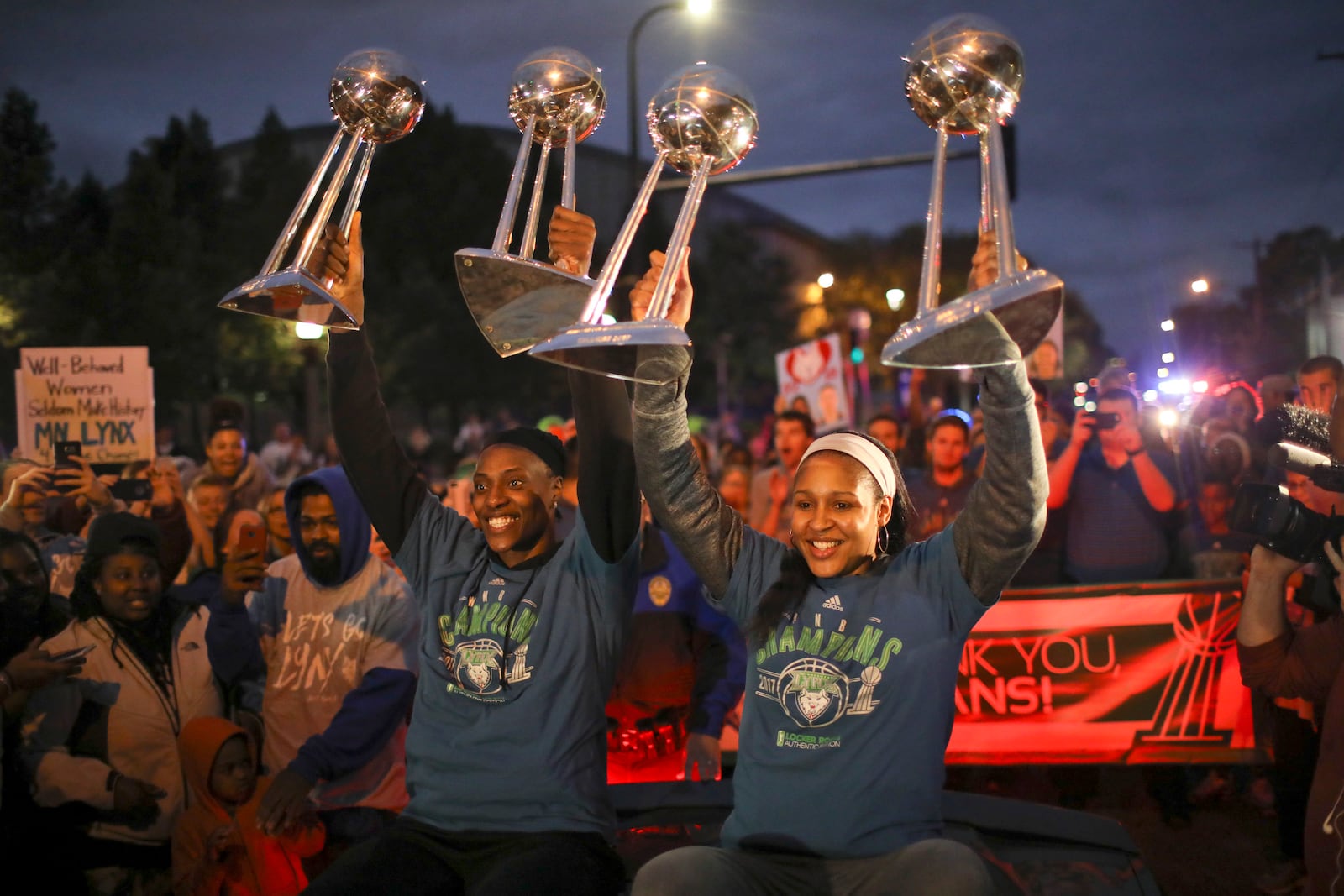 FILE - Minnesota Lynx players Sylvia Fowles, left and Maya Moore held up all four WNBA championship trophies as the team arrives at Williams Arena for a celebration Thursday night, Oct. 5, 2017, in Minneapolis. (Jeff Wheeler/Star Tribune via AP, File)