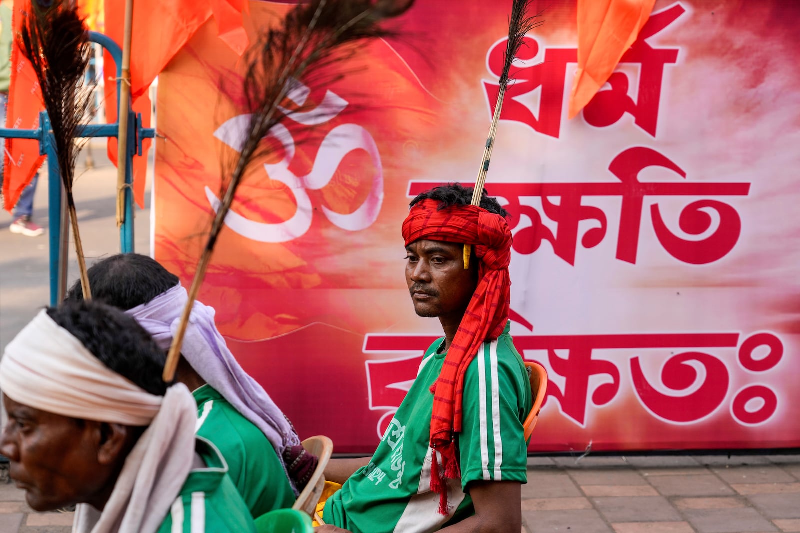 A member of tribal community attends a protest rally condemning the recent arrest of prominent Hindu leader Krishna Das Prabhu and the alleged attacks on Hindus in Bangladesh, in Kolkata, India, Thursday, Dec. 5, 2024. Banner in Bangla reads, Religion is protected. (AP Photo/Bikas Das)