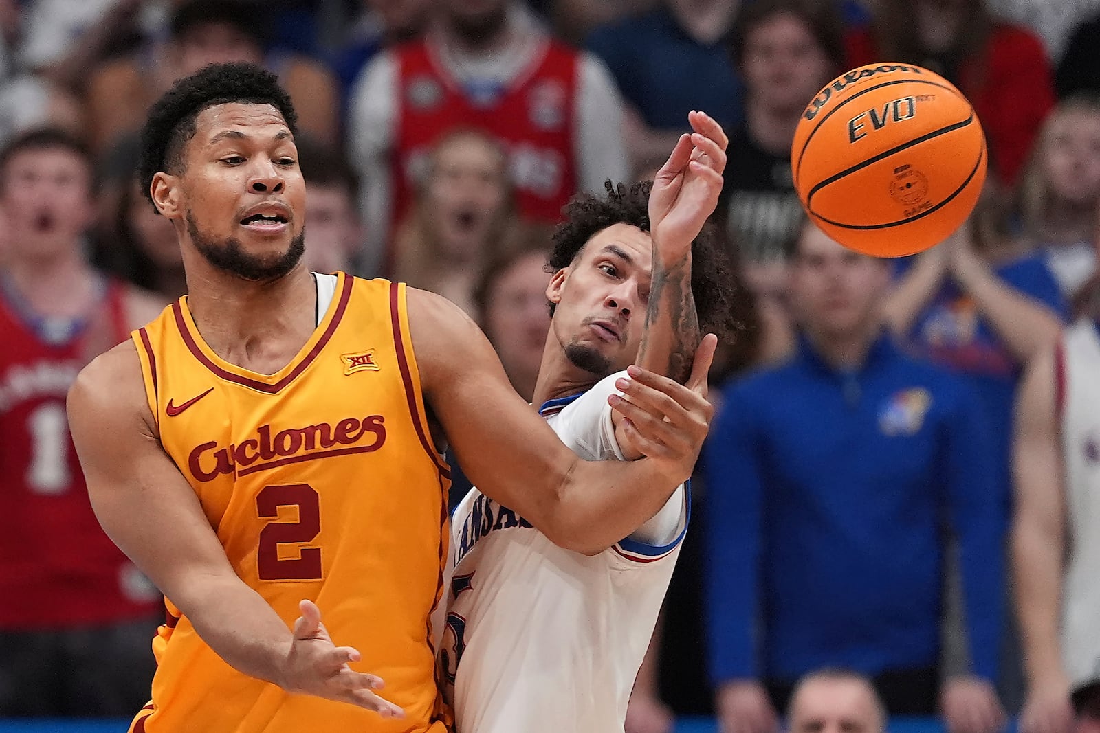 Iowa State forward Joshua Jefferson (2) and Kansas guard Zeke Mayo chase a loose ball during the first half of an NCAA college basketball game, Monday, Feb. 3, 2025, in Lawrence, Kan. (AP Photo/Charlie Riedel)