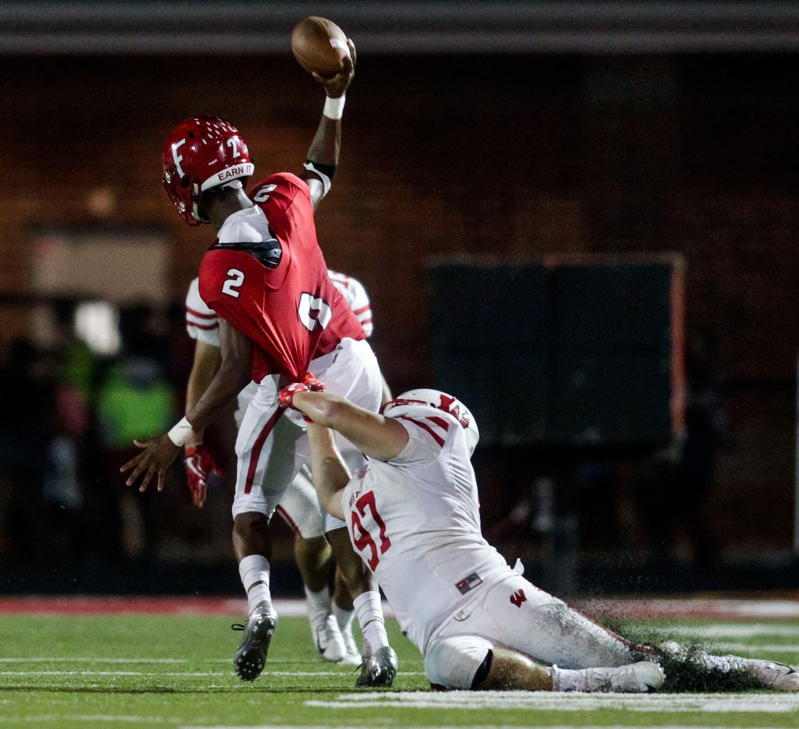 Fairfield quarterback Sawiaha Ellis releases the ball as he is pulled down by Lakota West’s Jacob Kieffer during Friday night’s game at Fairfield Stadium. The host Indians rolled to a 37-3 victory. NICK GRAHAM/STAFF