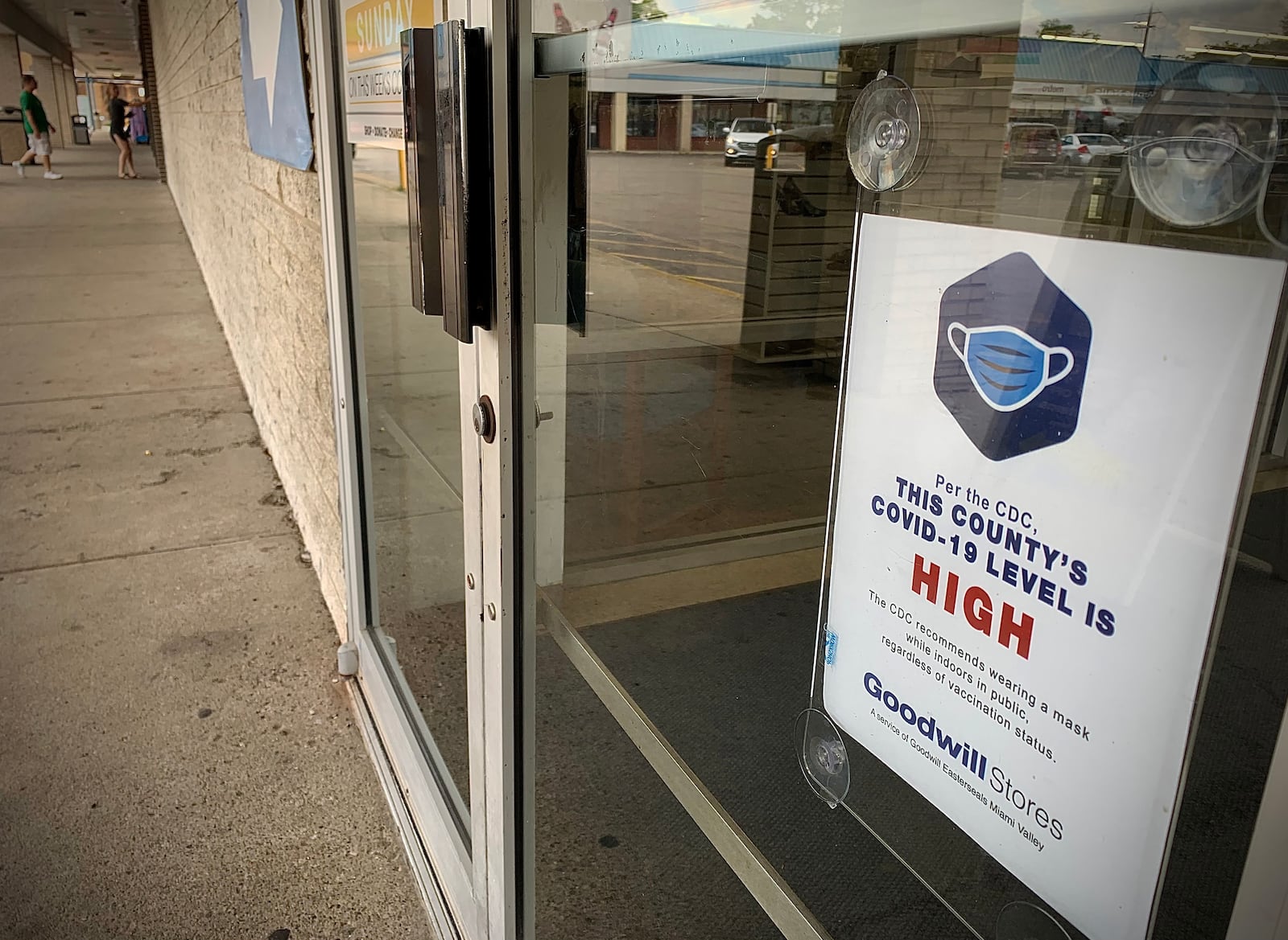 A majority of the Miami Valley is now under a high COVID-19 community level. This sign on the door greeted customers at the Goodwill store on Patterson Road on Friday July 22, 2022. MARSHALL GORBY\STAFF