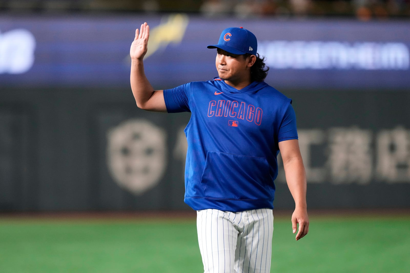 Chicago Cubs' Shota Imanaga waves to fans during warmups before an MLB Japan Series exhibition baseball game against the Yomiuri Giants in Tokyo, Japan, Sunday, March 16, 2025. (AP Photo/Eugene Hoshiko)