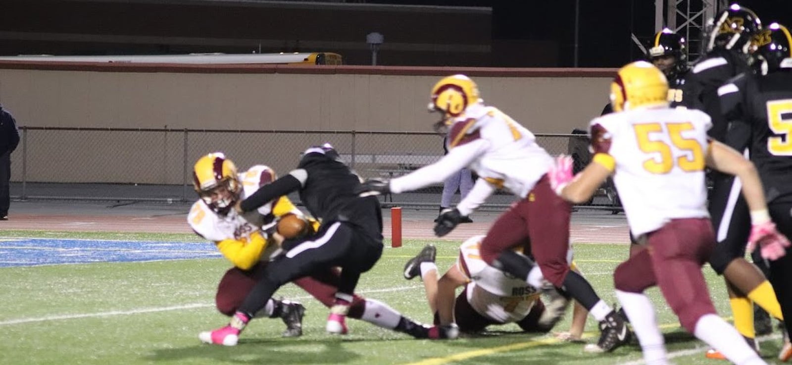 Andrew Redemeier (78) of Ross nearly causes Meadowdale’s Jermaine Graves (5) to fumble during Thursday night’s game at Welcome Stadium in Dayton. Ross posted a 52-6 victory. CONTRIBUTED PHOTO BY KAREN REDEMEIER