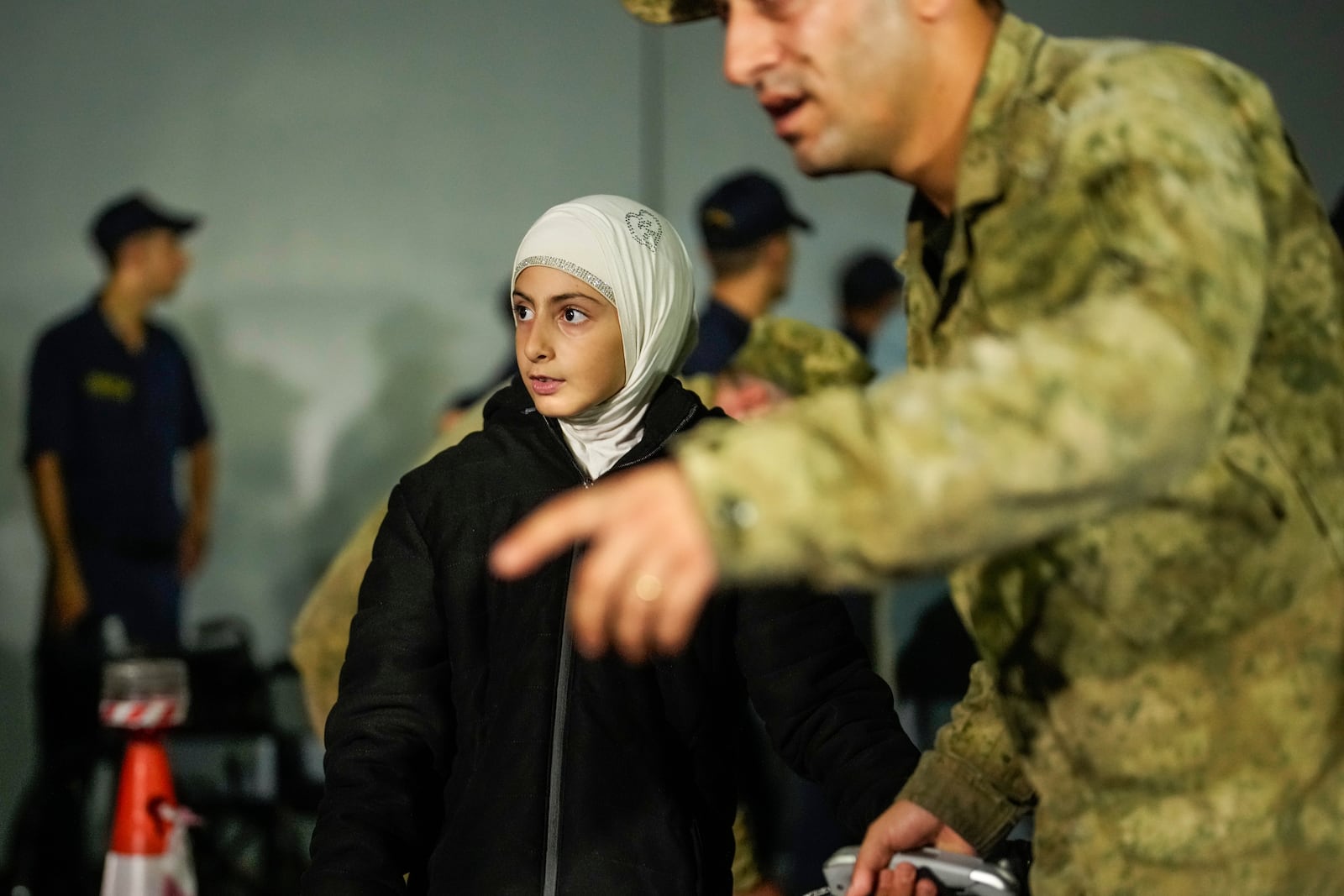 People, mostly Turkish nationals, disembark from Turkish TCG Sancaktar military ship after being evacuated from Lebanon's capital Beirut to Turkey, in Mersin port, southern Turkey, early Friday, Oct. 11, 2024. (AP Photo/Emrah Gurel)