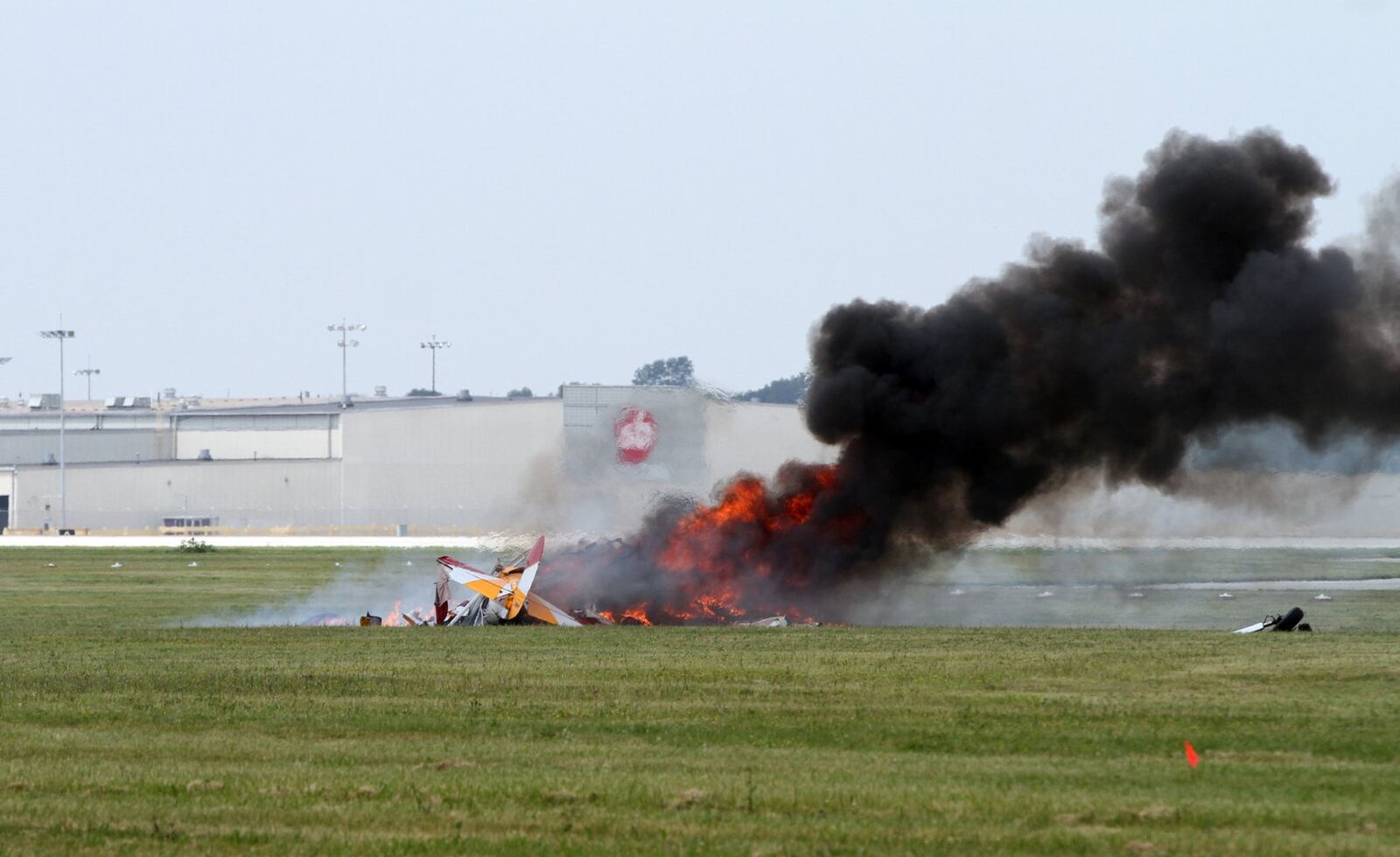 Wing walker Jane Wicker waves at the Vectren Dayton Air Show Crowd seconds before the plane hit the ground killing her and the pilot at approximately 12:45 p.m. at the Vectren Dayton Air Show. DARIN POPE / STAFF.