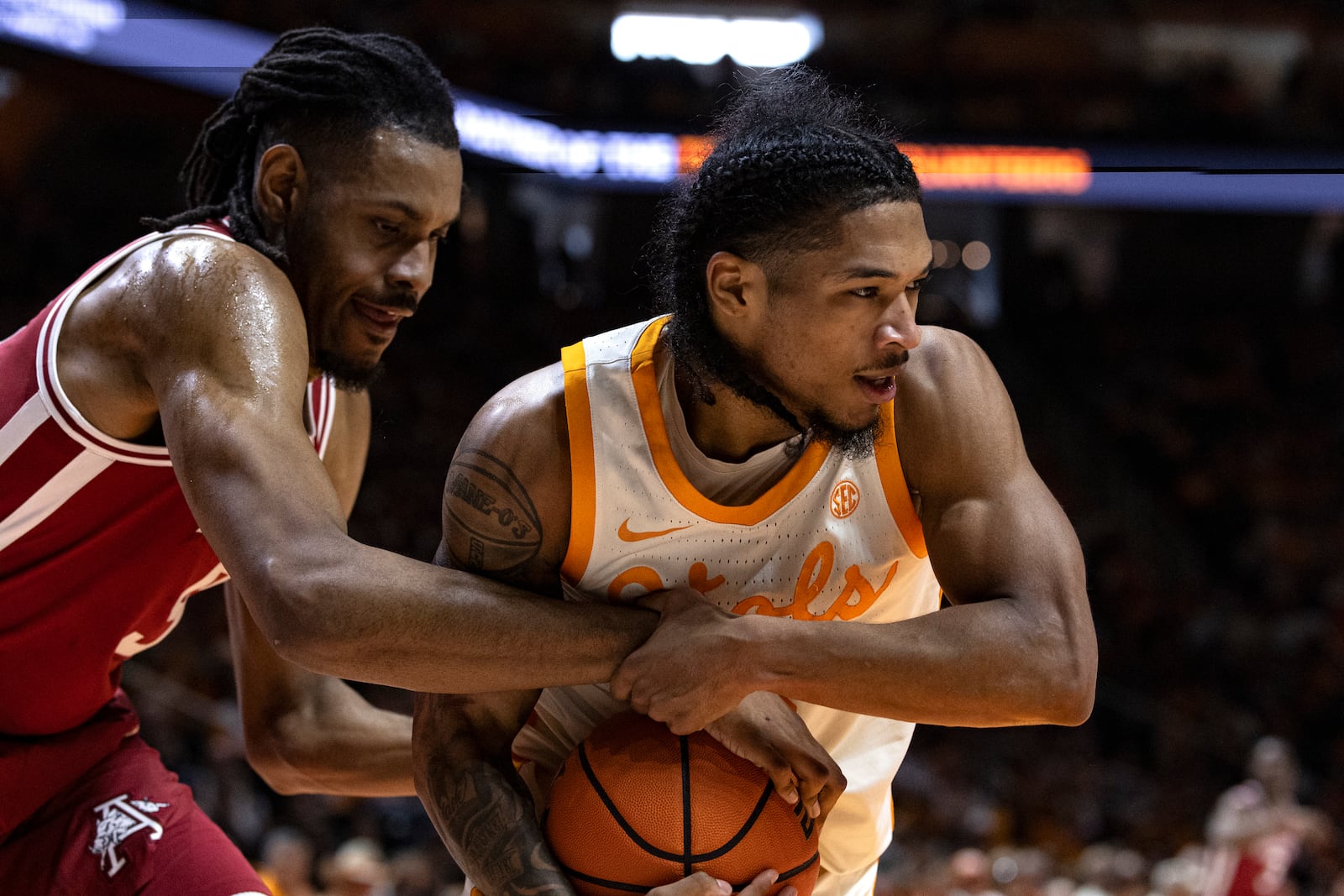 Tennessee guard Zakai Zeigler, right, fights for the ball with Arkansas forward Jonas Aidoo during the first half of an NCAA college basketball game Saturday, Jan. 4, 2025, in Knoxville, Tenn. (AP Photo/Wade Payne)