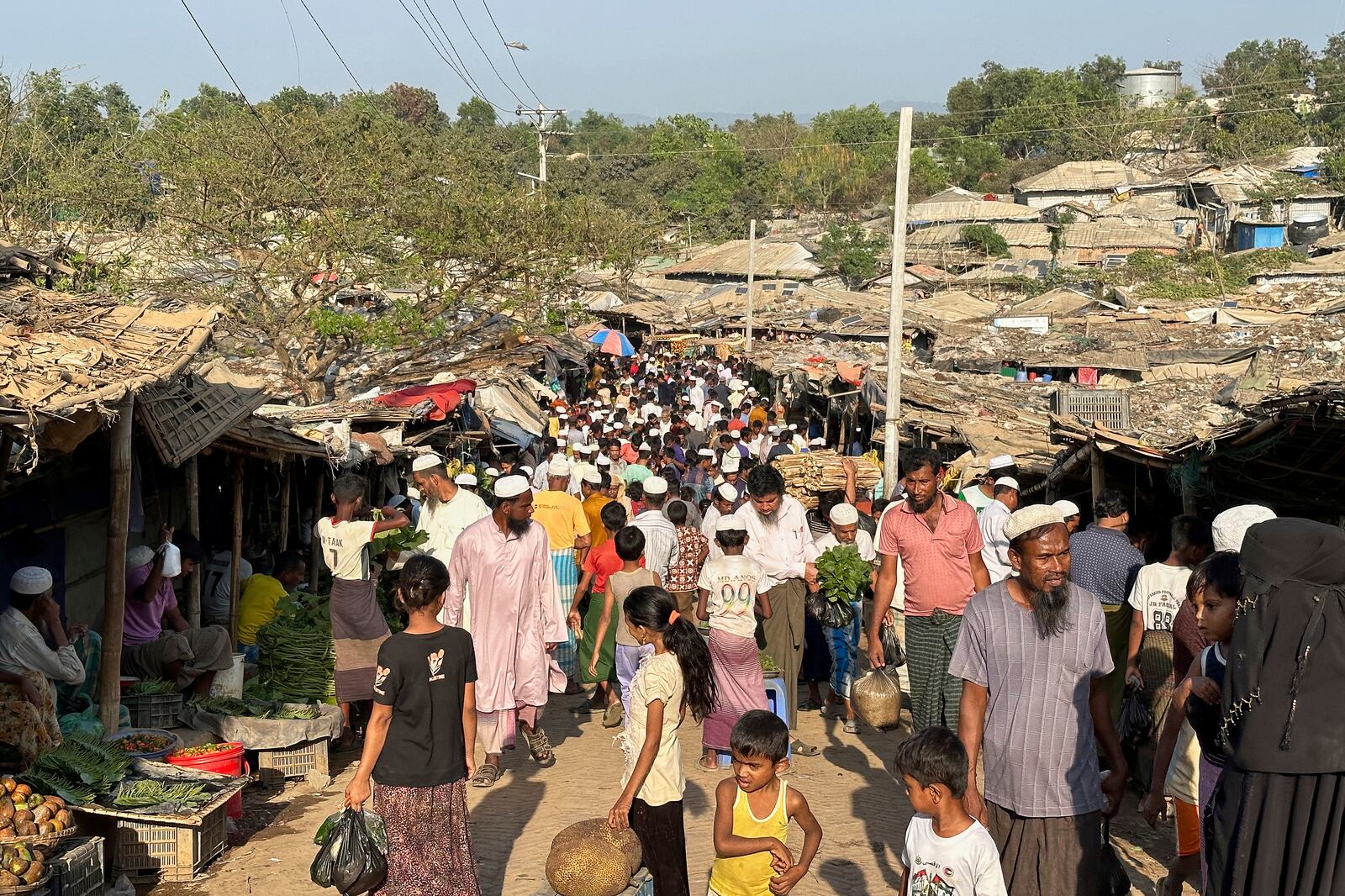 Rohingya refugees shop at a market inside their refugee camp at Kutupalong in Cox's Bazar, Bangladesh, Thursday, March 6, 2025. (AP Photo/Shafiqur Rahman)