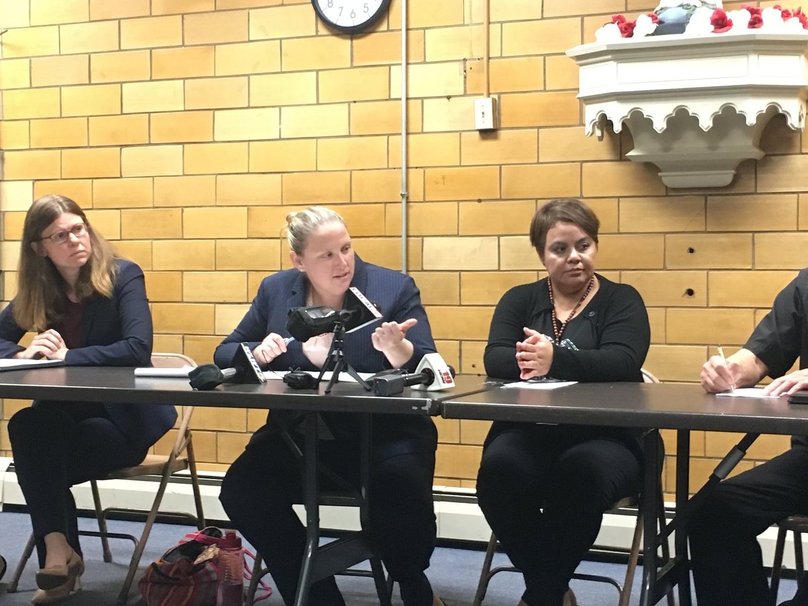 Maribel Trujillo Diaz, right, sat next to her lawyers, from left, Emily Brown and Kathleen Kersh, during a brief news conference Tuesday. 