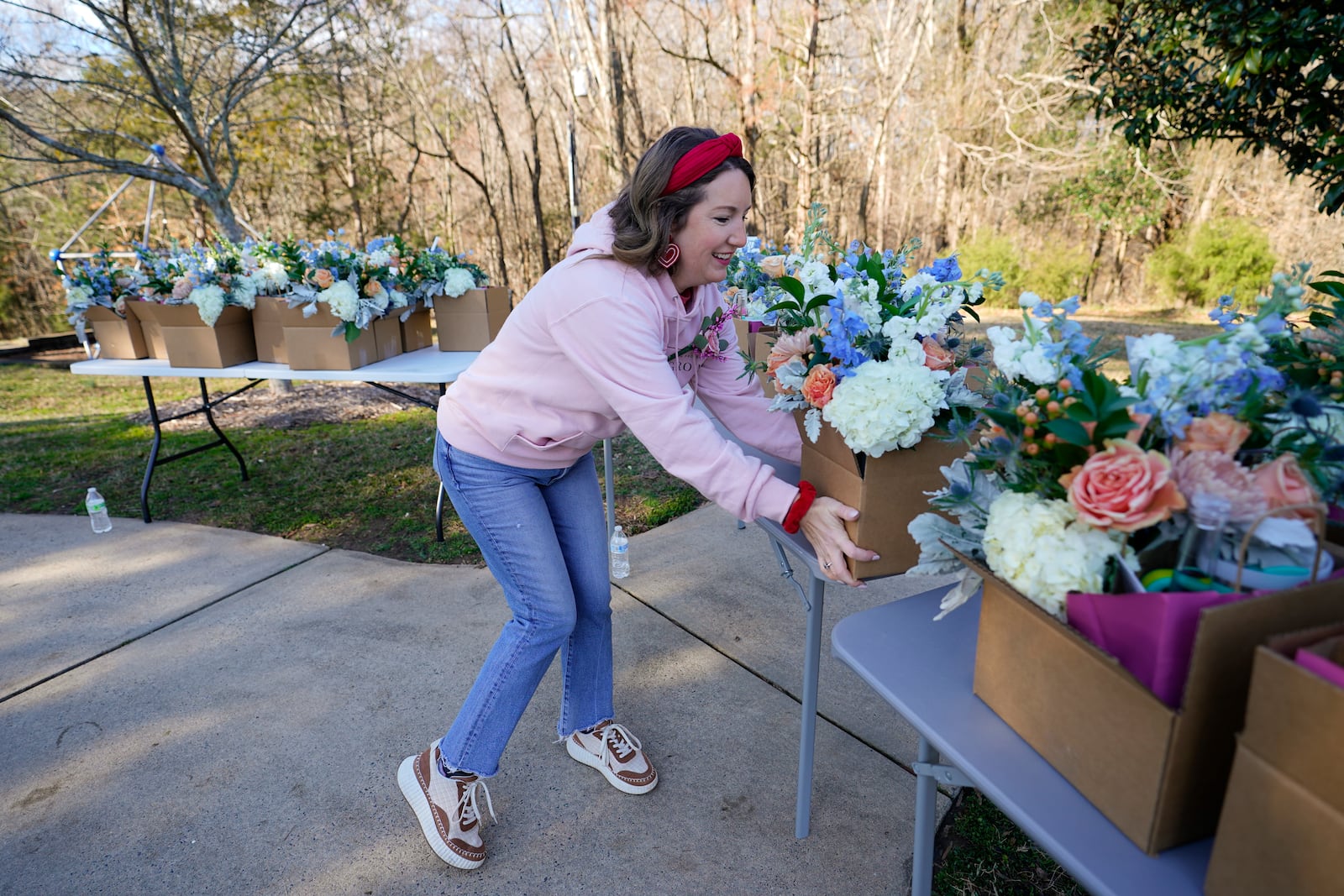 Volunteer and widow Jillian Myers, organizes gift boxes during a Valentine's Day Widow Outreach Project event, Friday, Feb. 14, 2025, in Charlotte, N.C. (AP Photo/Erik Verduzco)