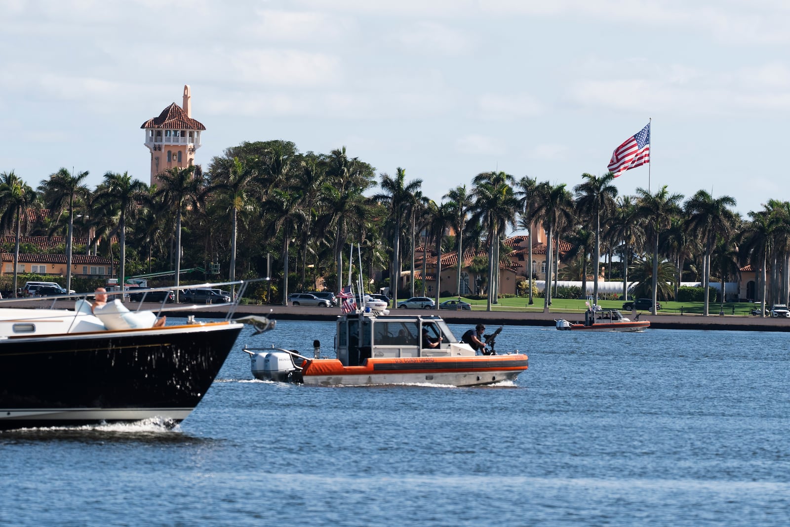 The U.S. flag is shown at Mar-a-Lago compound in Palm Beach, Fla., while a U.S. Coast Guard boat patrols around the vicinity, Monday, Jan. 13, 2025. U.S. flags at President-elect Donald Trump's private Mar-a-Lago club are back to flying at full height. Flags are supposed to fly at half-staff through the end of January out of respect for former President Jimmy Carter, who died Dec. 29. (AP Photo/Manuel Balce Ceneta)