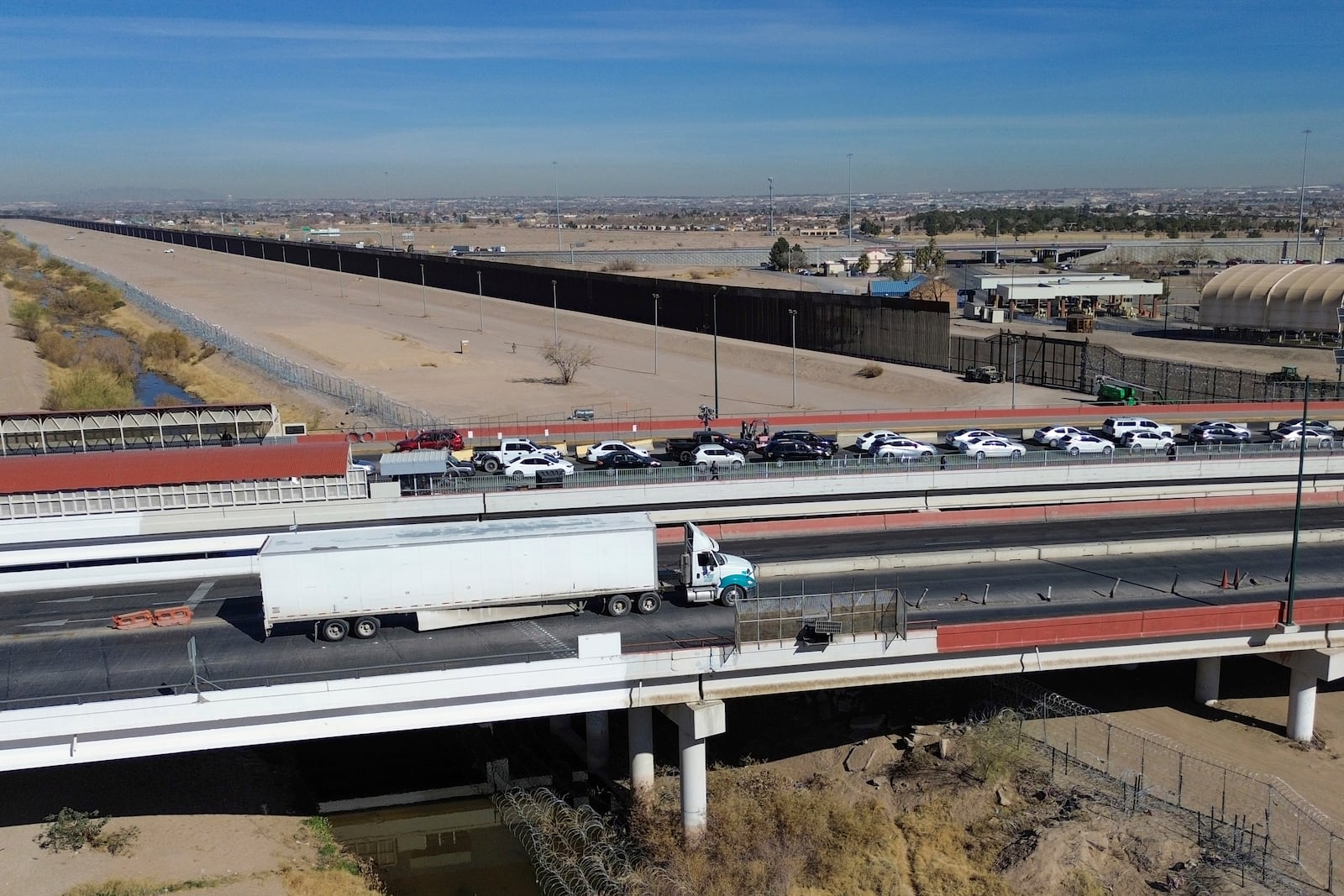 FILE - A truck, bottom, crosses the Zaragoza International Bridge into the U.S., in Ciudad Juarez, Mexico, Monday, Feb. 3, 2025. (AP Photo/Christian Chavez, File)