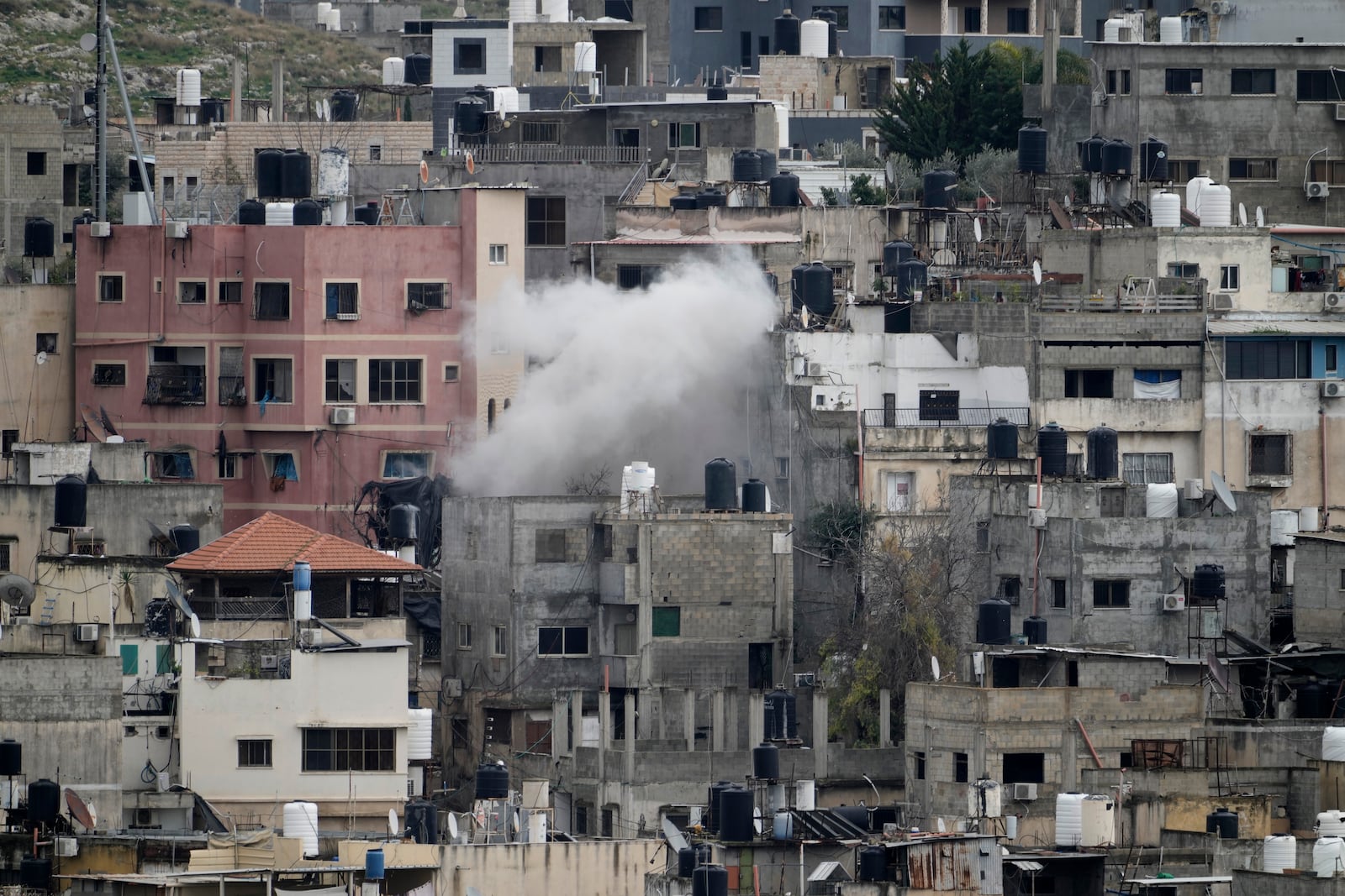 Smoke rises from an ongoing Israeli military operation in the West Bank Nur Shams refugee camp, Wednesday, Feb. 12, 2025. (AP Photo/Majdi Mohammed)