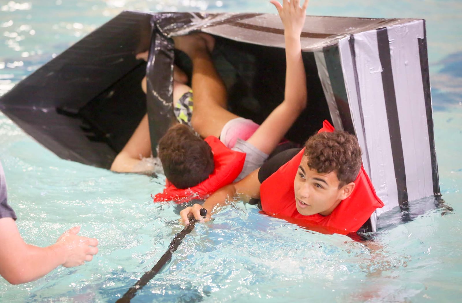 Students from Lakota East, including Nick Branson and Fabian Guzman participate in a cardboard regatta at the Lakota YMCA, Friday, May 19, 2017. The Butler Tech, Project Lead the Way, Intro to Engineer Design program tested students design and teamwork skills. GREG LYNCH / STAFF