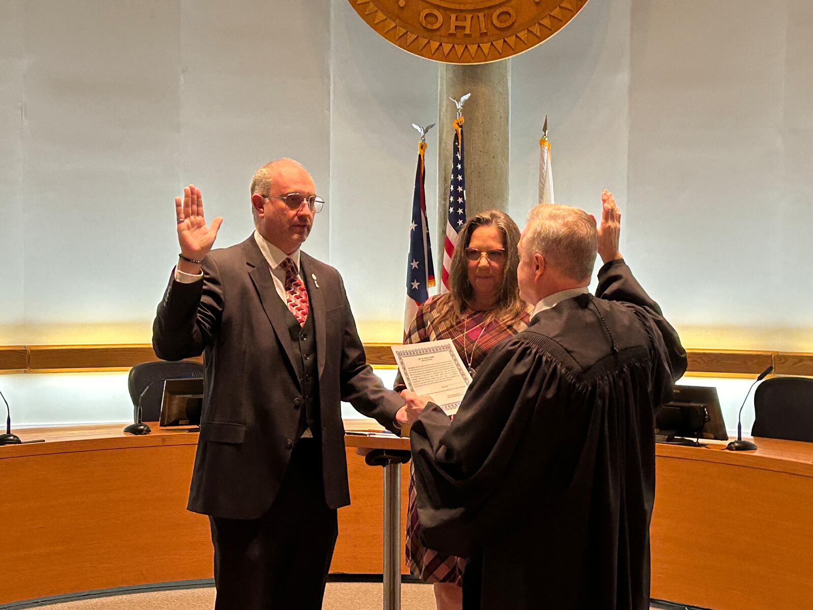 Paul Horn is sworn-in Tuesday night as a Middletown City Council member by Municipal Court Judge James Sherron. His girlfriend, Maureen Schumacker, holds the Bible. RICK McCRABB/STAFF