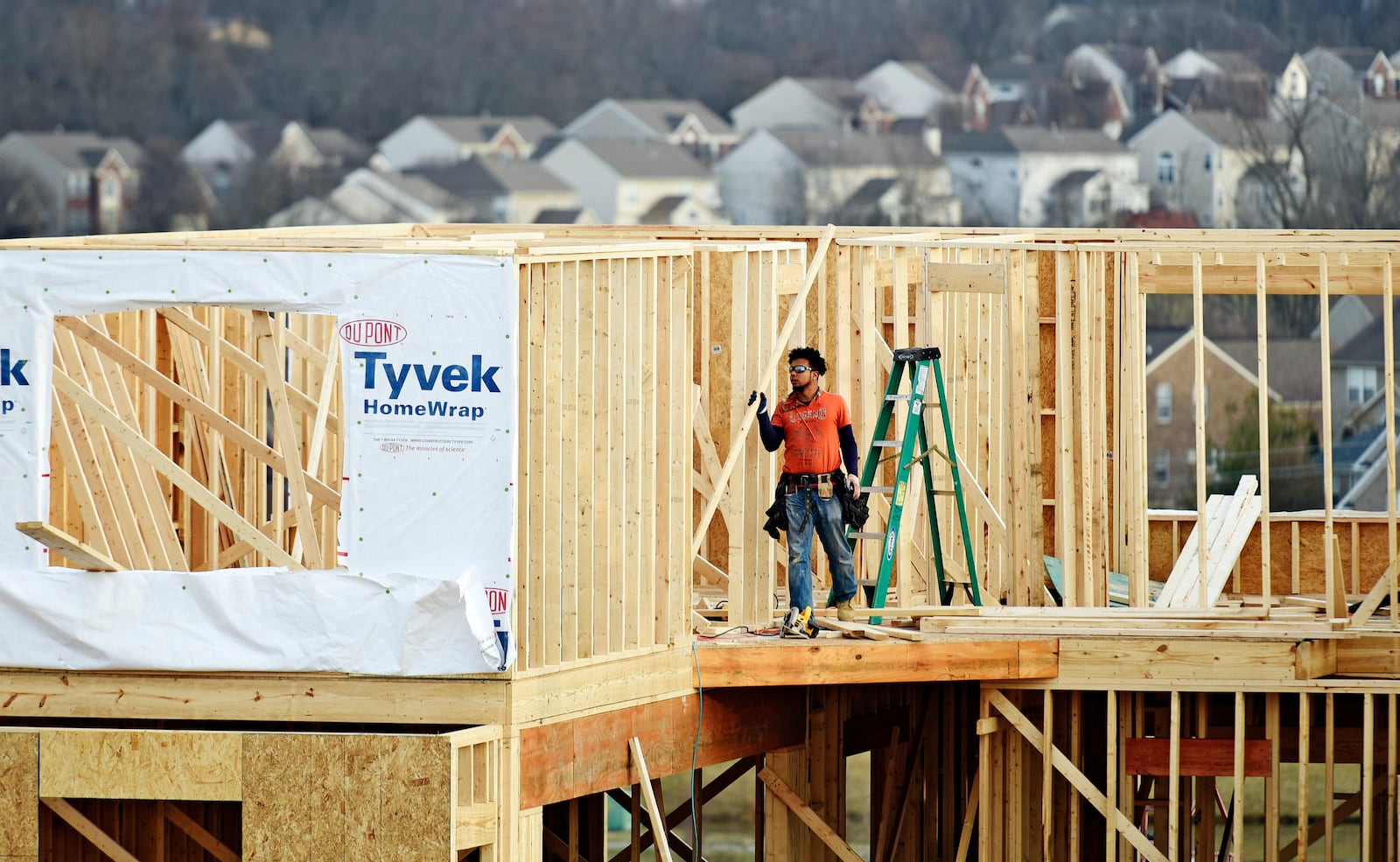 A crew works on construction of a new home on Elm Leaf Trail Monday, Feb. 20, in Liberty Twp. NICK GRAHAM/STAFF