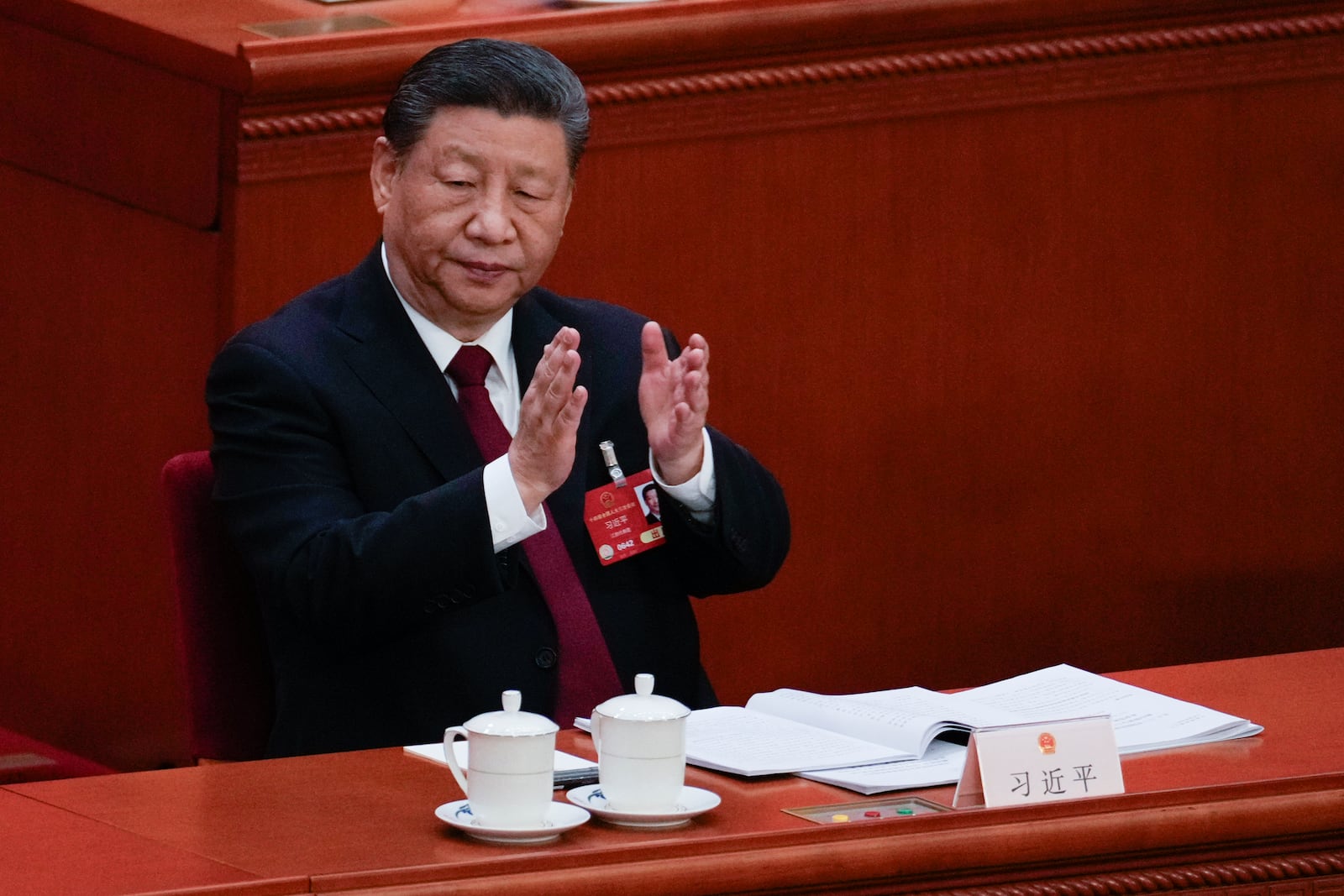 Chinese President Xi Jinping applauds during the opening session of the National People's Congress (NPC) at the Great Hall of the People in Beijing, China, Wednesday, March 5, 2025. (AP Photo/Andy Wong)