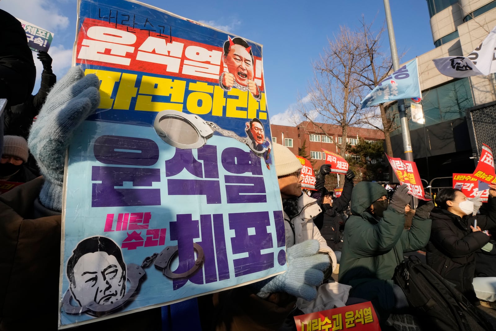 Protesters attend a rally demanding the arrest of impeached South Korean President Yoon Suk Yeol near the presidential residence in Seoul, South Korea, Wednesday, Jan. 8, 2025. The letters read, "Arrest Yoon Suk Yeol." (AP Photo/Ahn Young-joon)