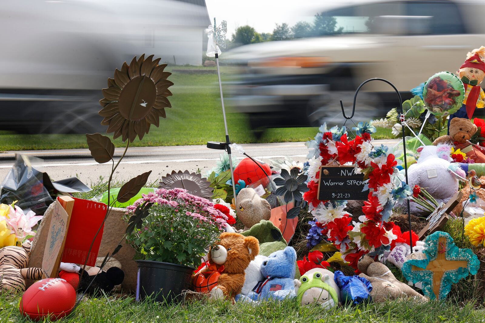 Memorial items and toys are stacked along Troy Road Thursday, August 24, 2023 at the site of Tuesday fatal bus crash. BILL LACKEY/STAFF