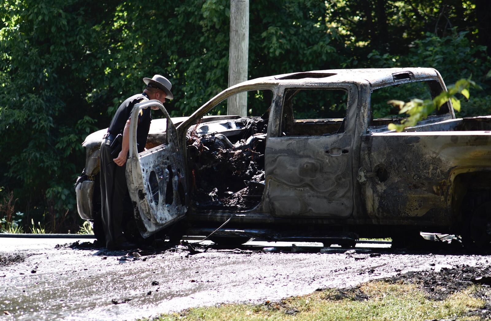 Firefighters battled a blaze in the 7100 block of Elk Creek Road on Sunday, Aug. 4, 2019. A vehicle caught fire at 2:39 p.m near Elk Creek Baptist Church, and the flames spread to nearby brush, according to emergency dispatchers. NICK GRAHAM / STAFF