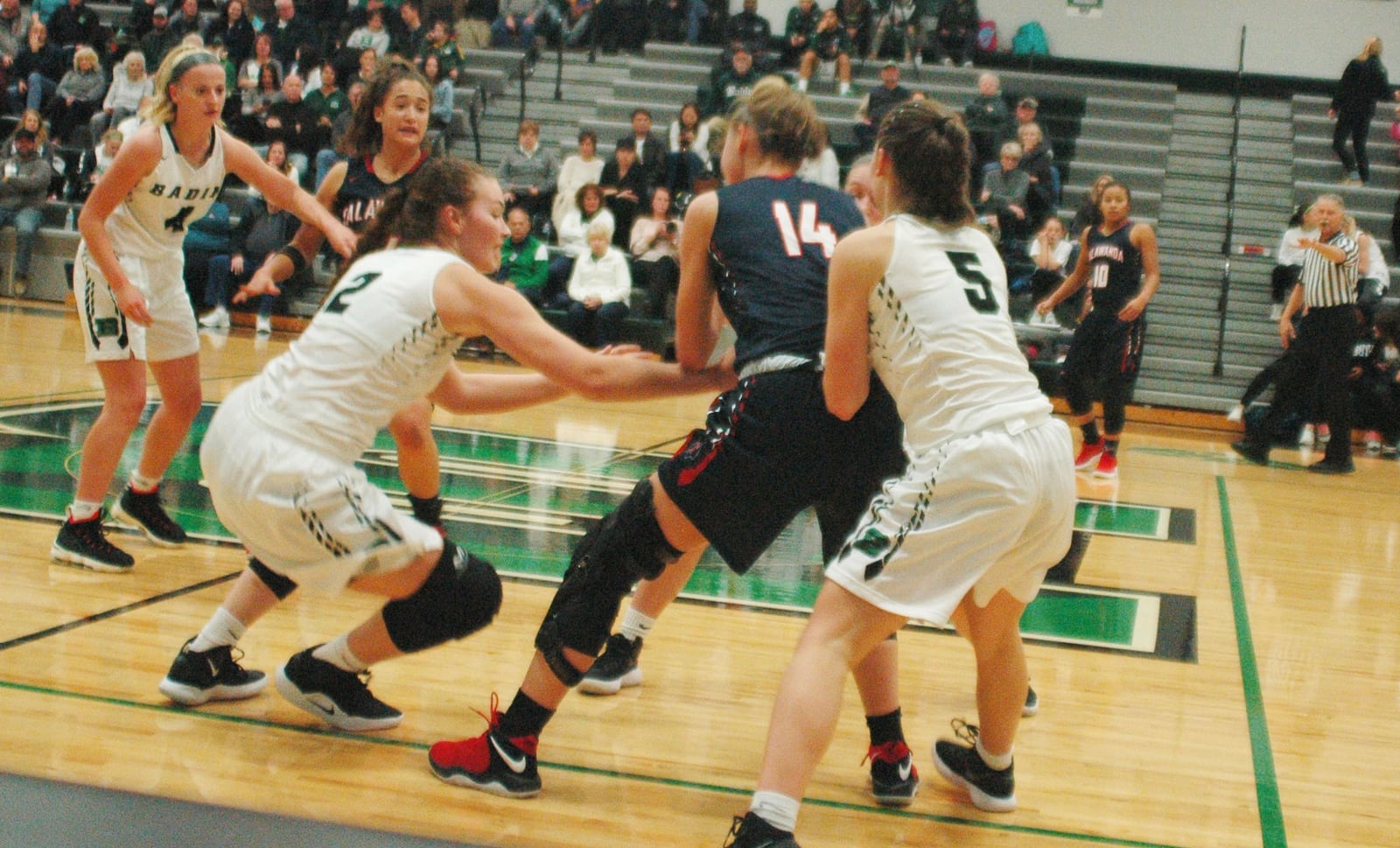 Badin’s Shelby Nusbaum (2) and Jaelynn Scowden (5) apply defensive pressure to Talawanda’s Sophie Pohlabel (14) during last Wednesday’s game at Mulcahey Gym in Hamilton. Badin won 79-36. RICK CASSANO/STAFF