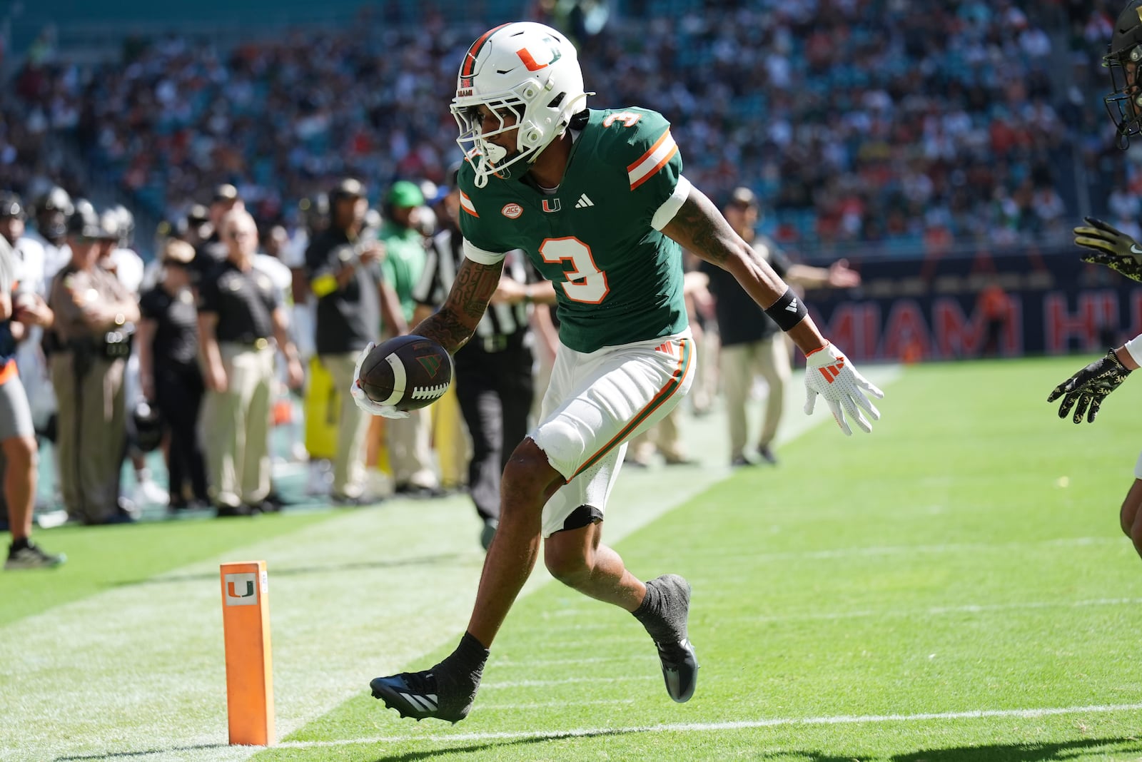 Miami wide receiver Jacolby George (3) runs for a touchdown during the first half of an NCAA college football game against against Wake Forest, Saturday, Nov. 23, 2024, in Miami Gardens, Fla. (AP Photo/Lynne Sladky)