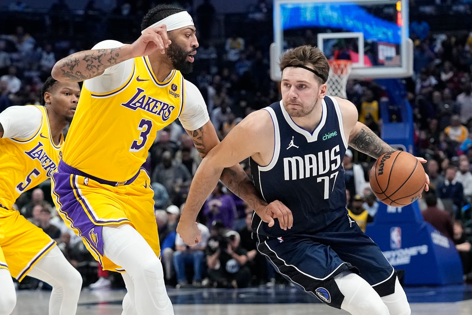 FILE - Dallas Mavericks guard Luka Doncic drives against Los Angeles Lakers forward Anthony Davis (3) during the first half of an NBA basketball game in Dallas, Tuesday, Dec. 12, 2023. (AP Photo/LM Otero, File)