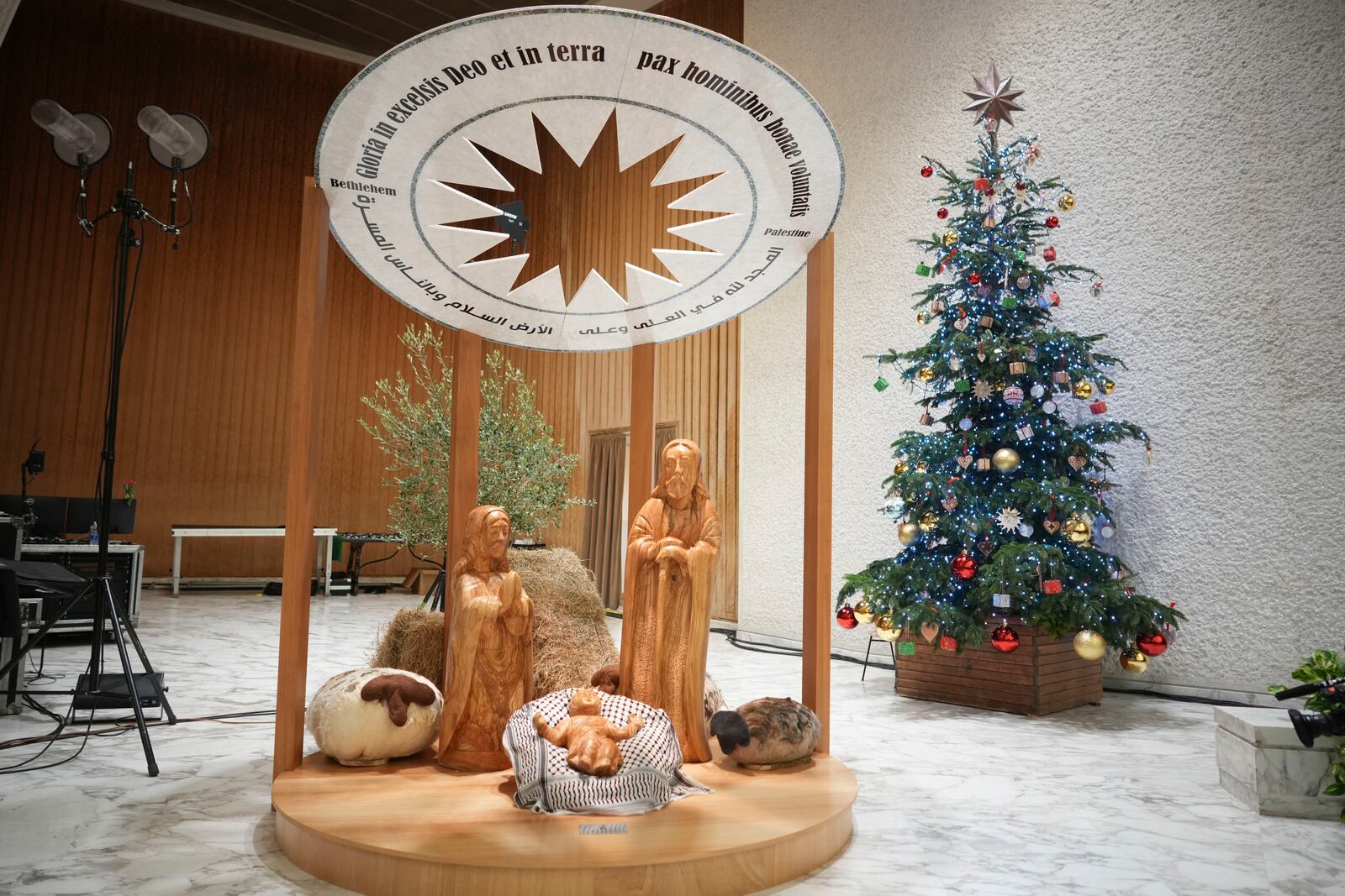 A view of Nativity Scene, crafted in the West Bank city of Bethlehem, with Baby Jesus' crib covered by a Palestinian kaffiyeh donated by delegates of the Palestinian Embassy to the Holy See, in the Pope Paul VI hall at the Vatican, Saturday, Dec. 7, 2024. (AP Photo/Andrew Medichini)