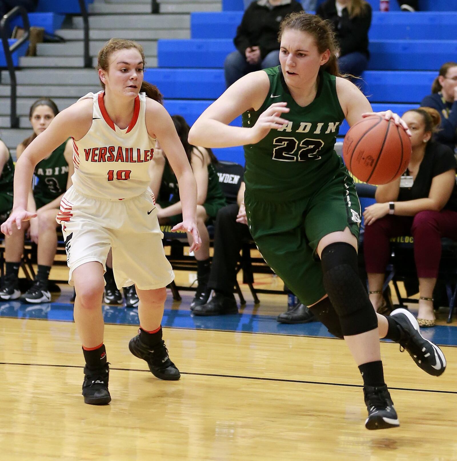 Badin’s Lauren Krause drives past Versailles’ Kami McEldowney en route to the basket Wednesday night during a Division III regional semifinal at Springfield. BILL LACKEY/STAFF