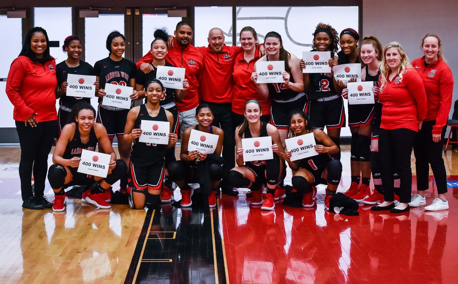 Lakota West’s girls basketball team poses for a photo Wednesday night after winning 61-50 at Princeton for coach Andy Fishman’s 400th career victory. NICK GRAHAM/STAFF