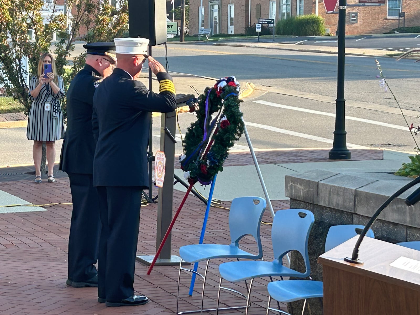 Monroe police Chief Bob Buchanan, left, and fire Chief David Leverage lay a wreath Monday morning during the city's 9/11 remembrance ceremony outside the City Building. RICK McCRABB/STAFF