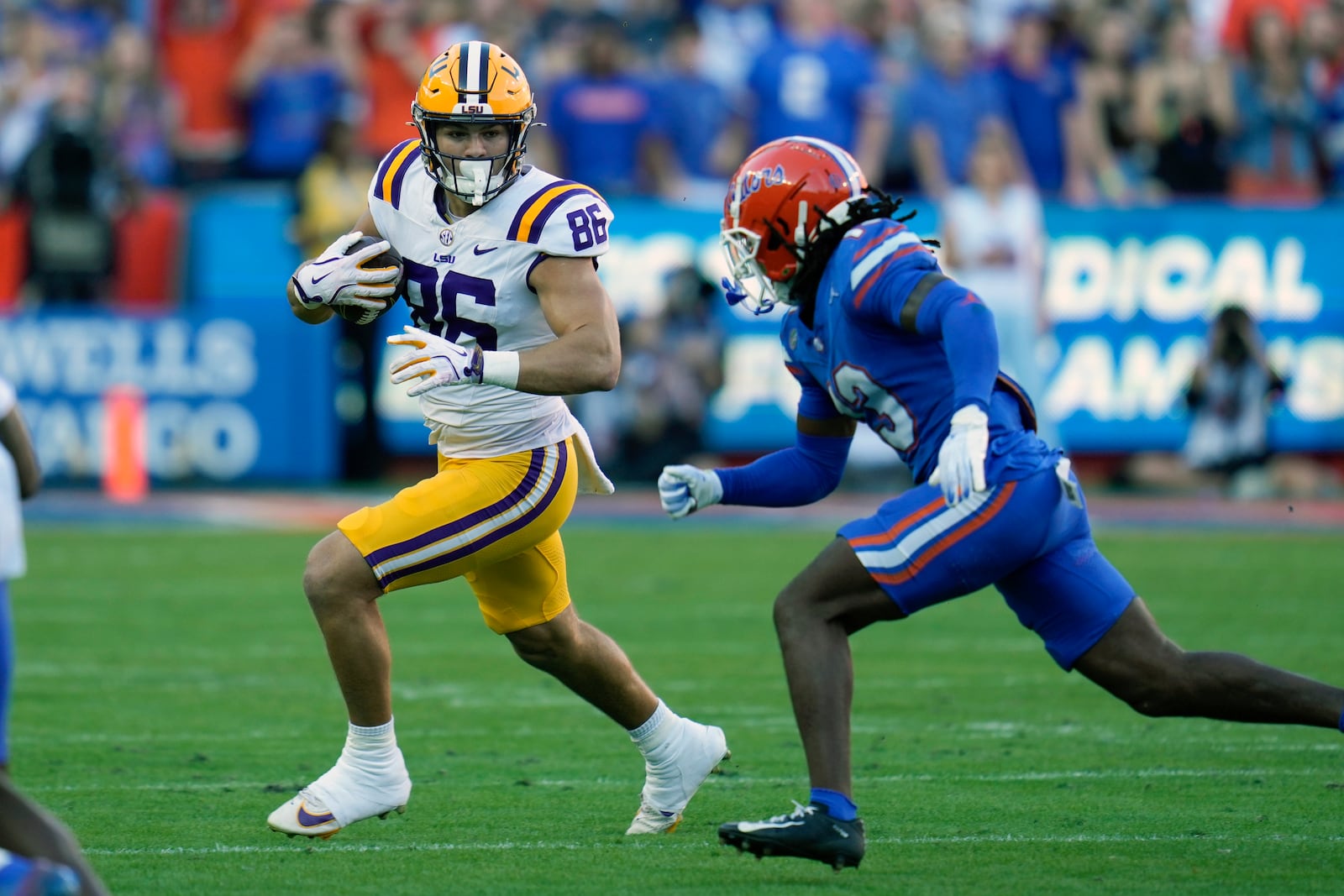 LSU tight end Mason Taylor (86) tries to get past Florida defensive back Aaron Gates after a reception during the first half of an NCAA college football game, Saturday, Nov. 16, 2024, in Gainesville, Fla. (AP Photo/John Raoux)