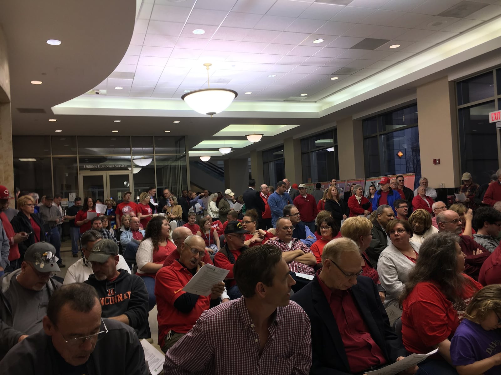 This is the part of the Hamilton City Council crowd that couldn’t fit inside the council chambers Wednesday, Feb. 22, 2017, for the planned hearings on proposed landlord legislation. Instead, they sat and stood in the city building’s lobby area. MIKE RUTLEDGE / STAFF