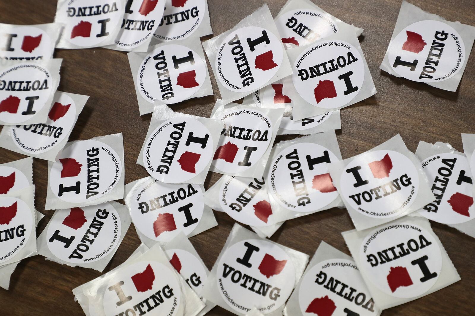 “I Love Voting” stickers wait for voters as they exit a Springfield election poll Tuesday. BILL LACKEY/STAFF