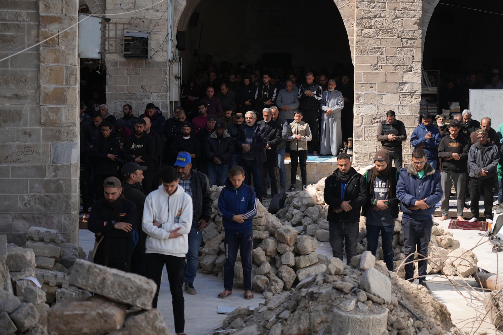 Palestinians take part in Friday prayers in the ruins of the Omari Mosque that was partially destroyed by Israeli bombardment, ahead of the start of the Muslim holy month of Ramadan in Gaza City, Gaza Strip, Friday, Feb. 28, 2025. (AP Photo/Abdel Kareem Hana)