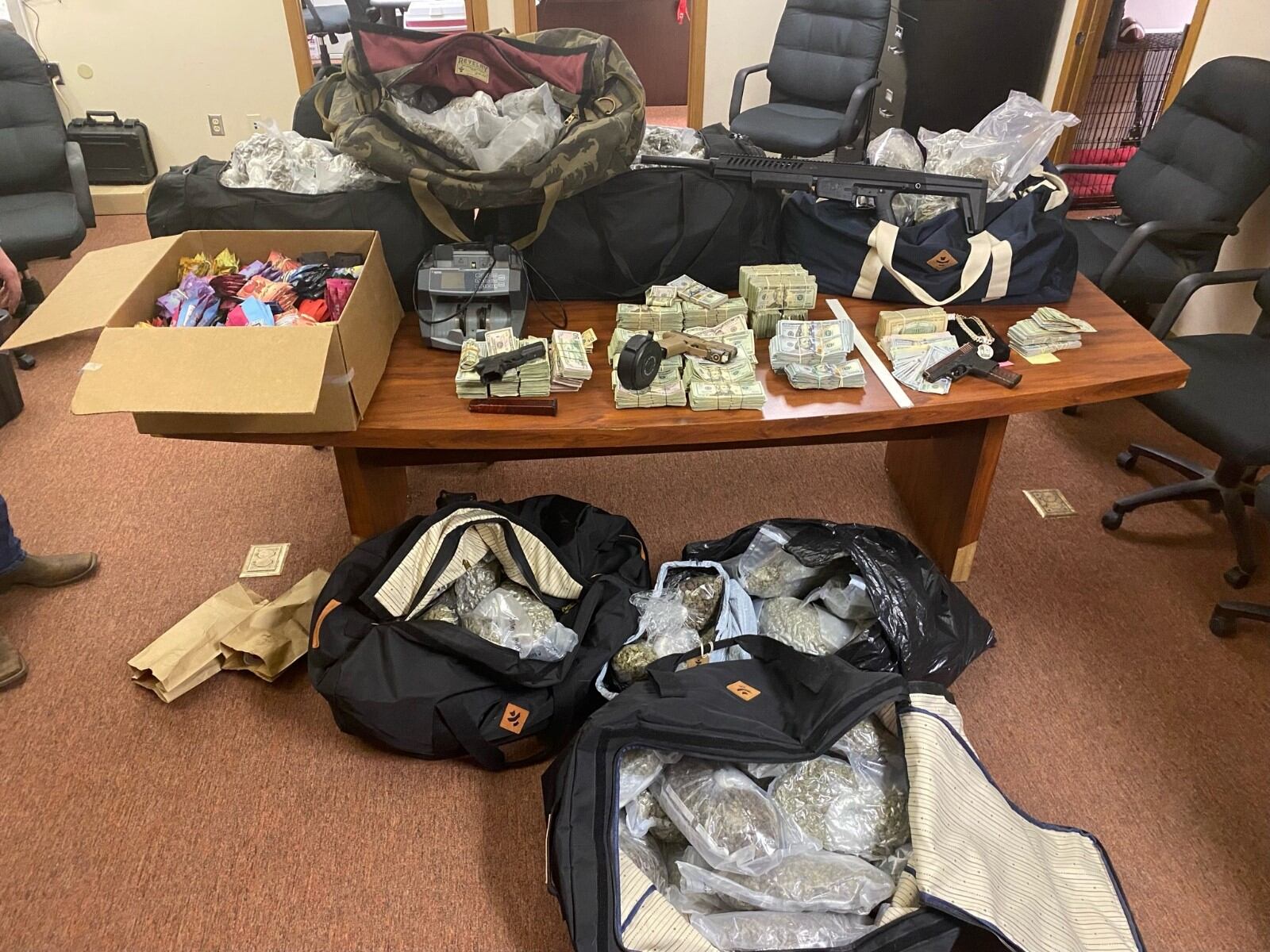 The Butler Undercover Regional Narcotics (BURN) task force seized large amounts of marijuana, firearms and cash in a raid on Carlton Drive in Hamilton and Oxford Middletown Road in Wayne Twp. CONTRIBUTED/BUTLER COUNTY SHERIFF'S OFFICE