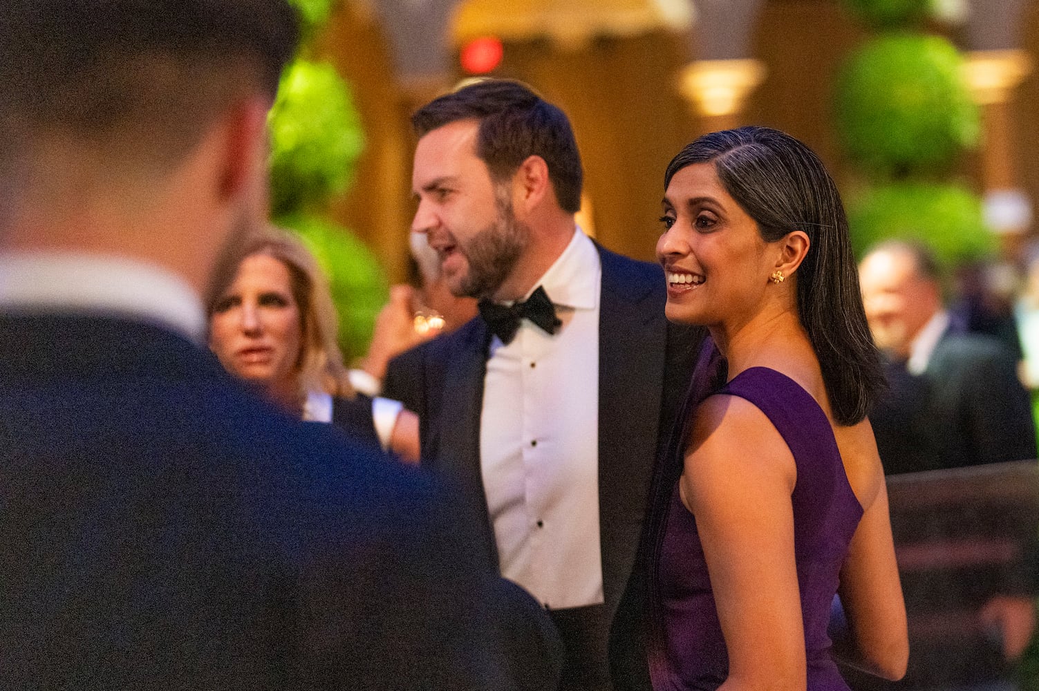 
                        Vice President-elect JD Vance and his wife Usha Vance speak to attendees while they wait for President-elect Donald Trump’s arrival during a candlelight dinner at the National Building Museum in Washington on Sunday, Jan. 19, 2025, the day before Trump’s inauguration. (Doug Mills/The New York Times)
                      