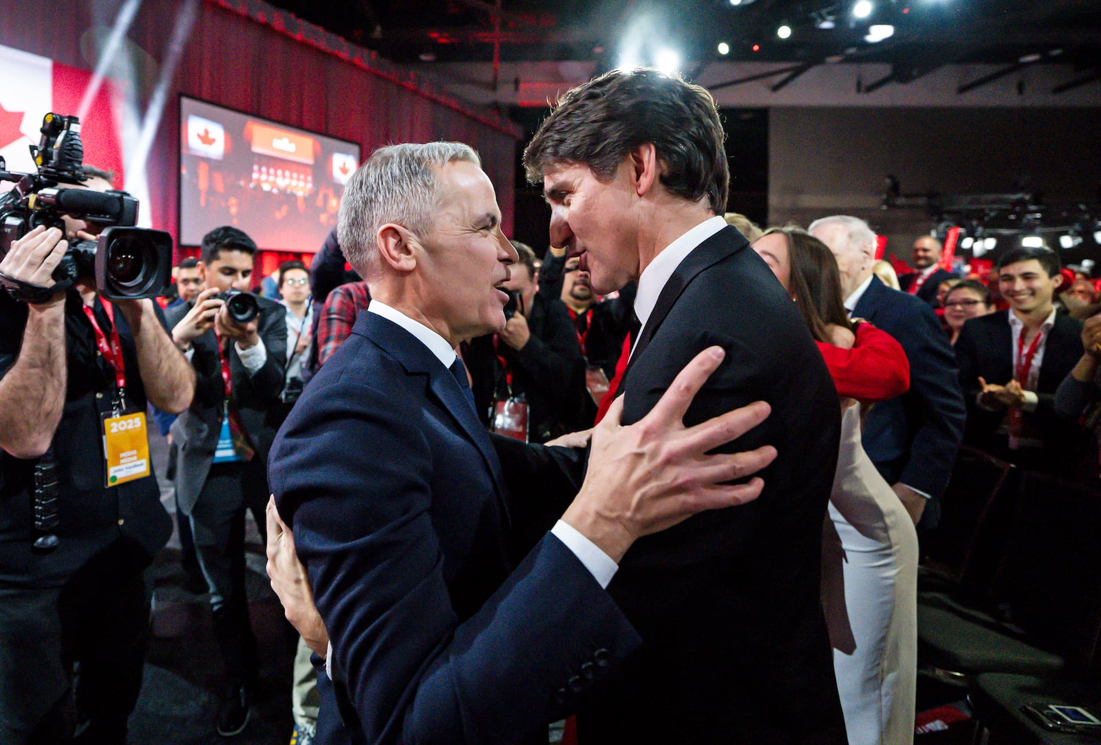 Mark Carney, Leader of the Liberal Party of Canada, embraces Prime Minister Justin Trudeau after being announced the winner at the Liberal leadership Event in Ottawa, Ontario, Sunday, March 9, 2025. (Justin Tang/The Canadian Press via AP)