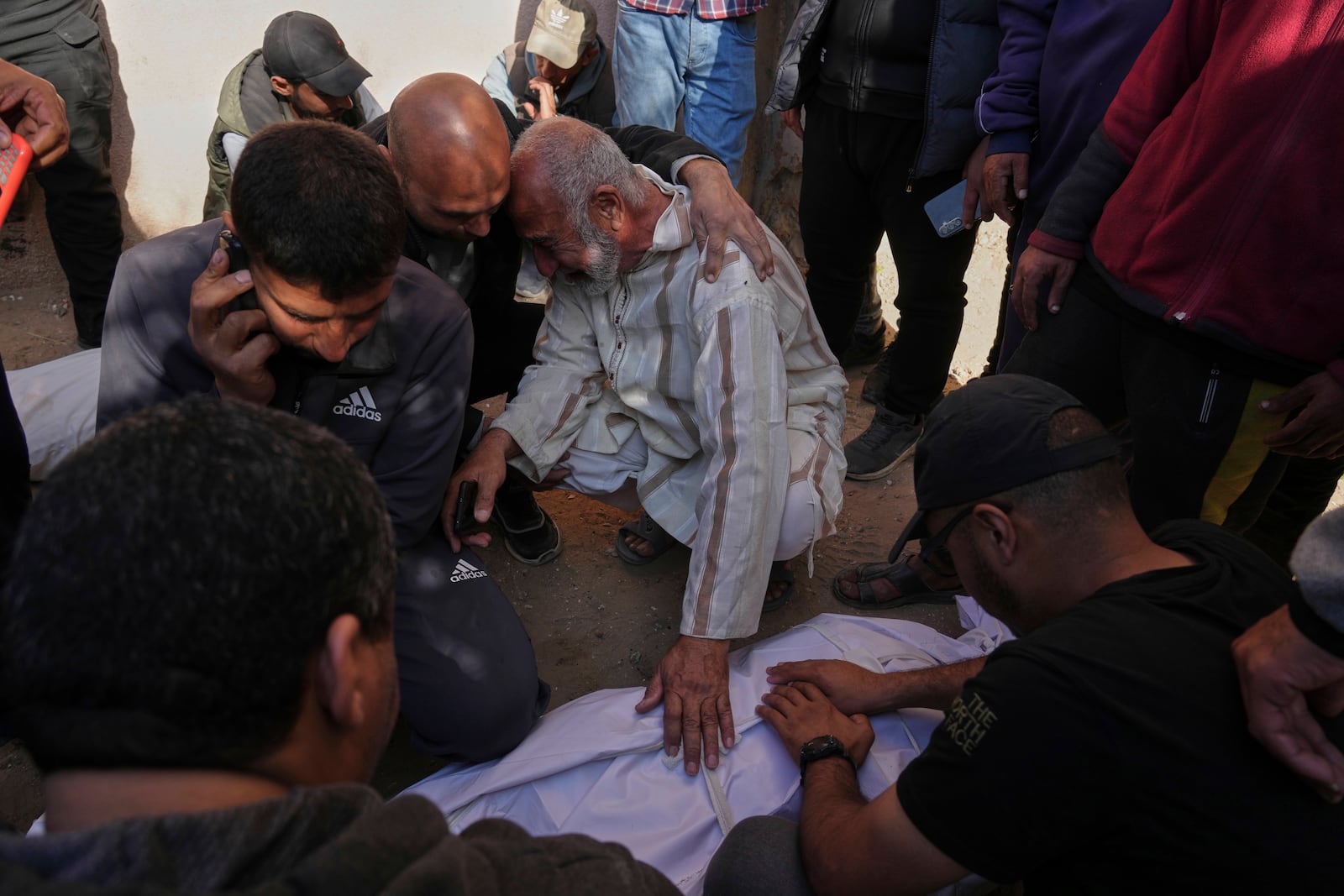 Palestinians mourn over the bodies of their relatives killed by an Israeli airstrike in Beit Lahiya, northern Gaza Strip on Saturday, March 15, 2025. (AP Photo/Jehad Alshrafi)