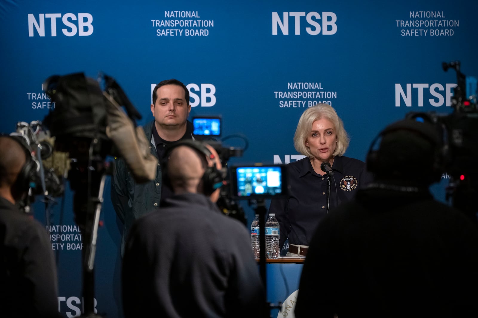 National Transportation Safety Board Chair Jennifer Homendy speaks as NTSB investigator Sean Payne listens during a news conference Friday, Feb. 14, 2025, in Washington. (AP Photo/Mark Schiefelbein)