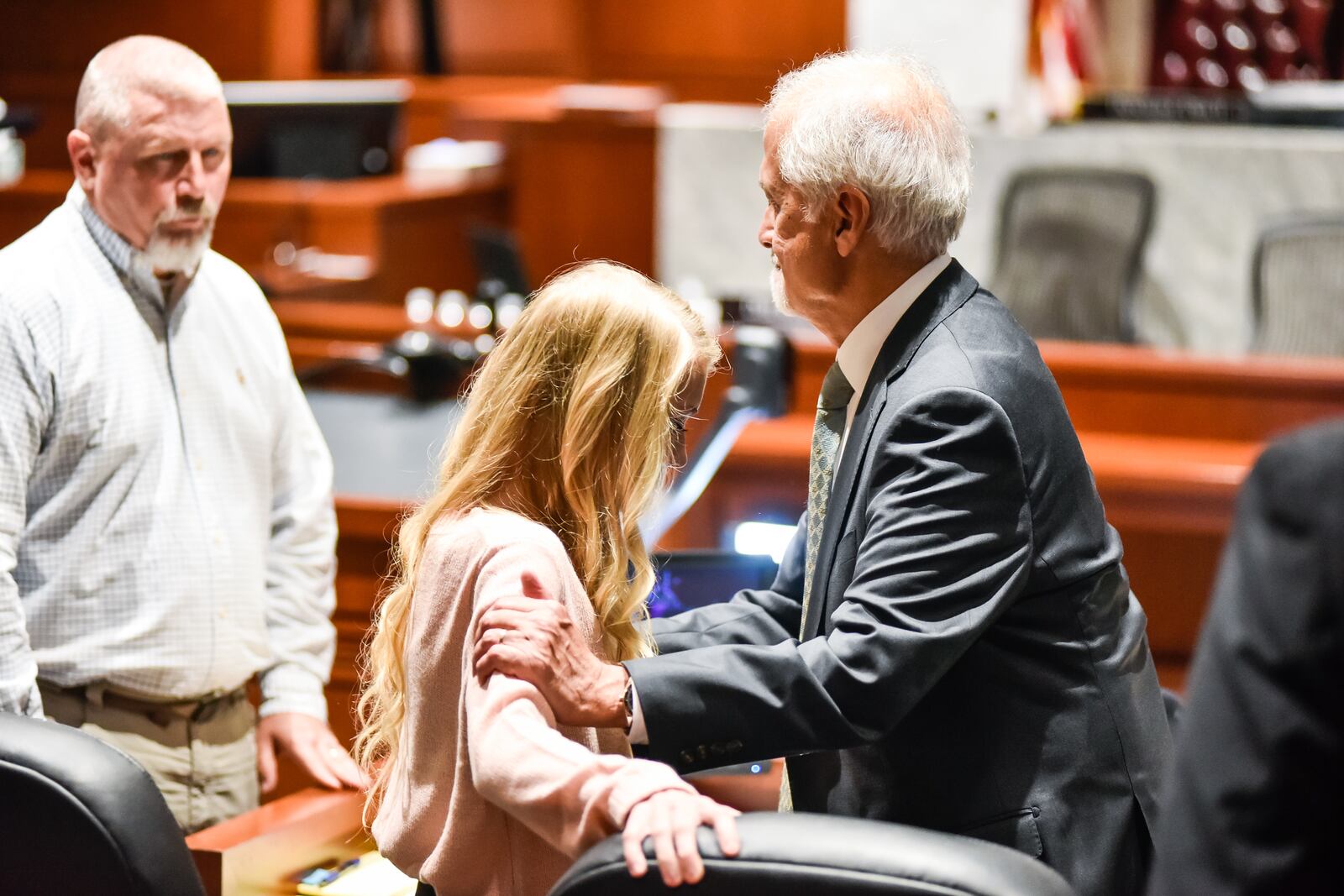 Brooke Skylar Richardson stands with attorney Charles H. Rittgers, right, with her father, Scott Richardson, behind her during a break in the Warren County Courthouse during her trial Monday, September 9, 2019. The 20-year-old is accused of killing and burying her baby in the backyard of her Carlisle home. Richardson is charged with aggravated murder, involuntary manslaughter, gross abuse of a corpse, tampering with evidence and child endangerment in the death of her newborn infant. She faces the possibility of life in prison. NICK GRAHAM/JOURNAL-NEWS/POOL