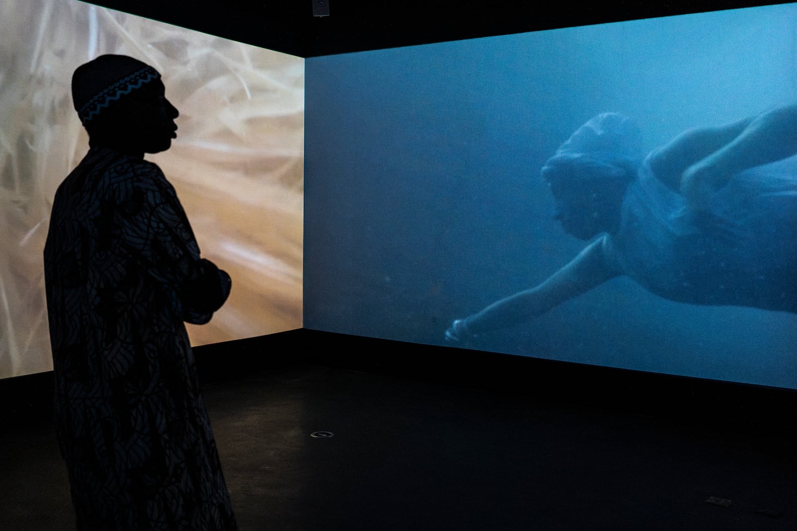 A visitor explores the international exhibit at the Dakar Biennale of Contemporary African Art in Dakar, Senegal, Friday, Nov. 8, 2024. (AP Photo/Annika Hammerschlag)