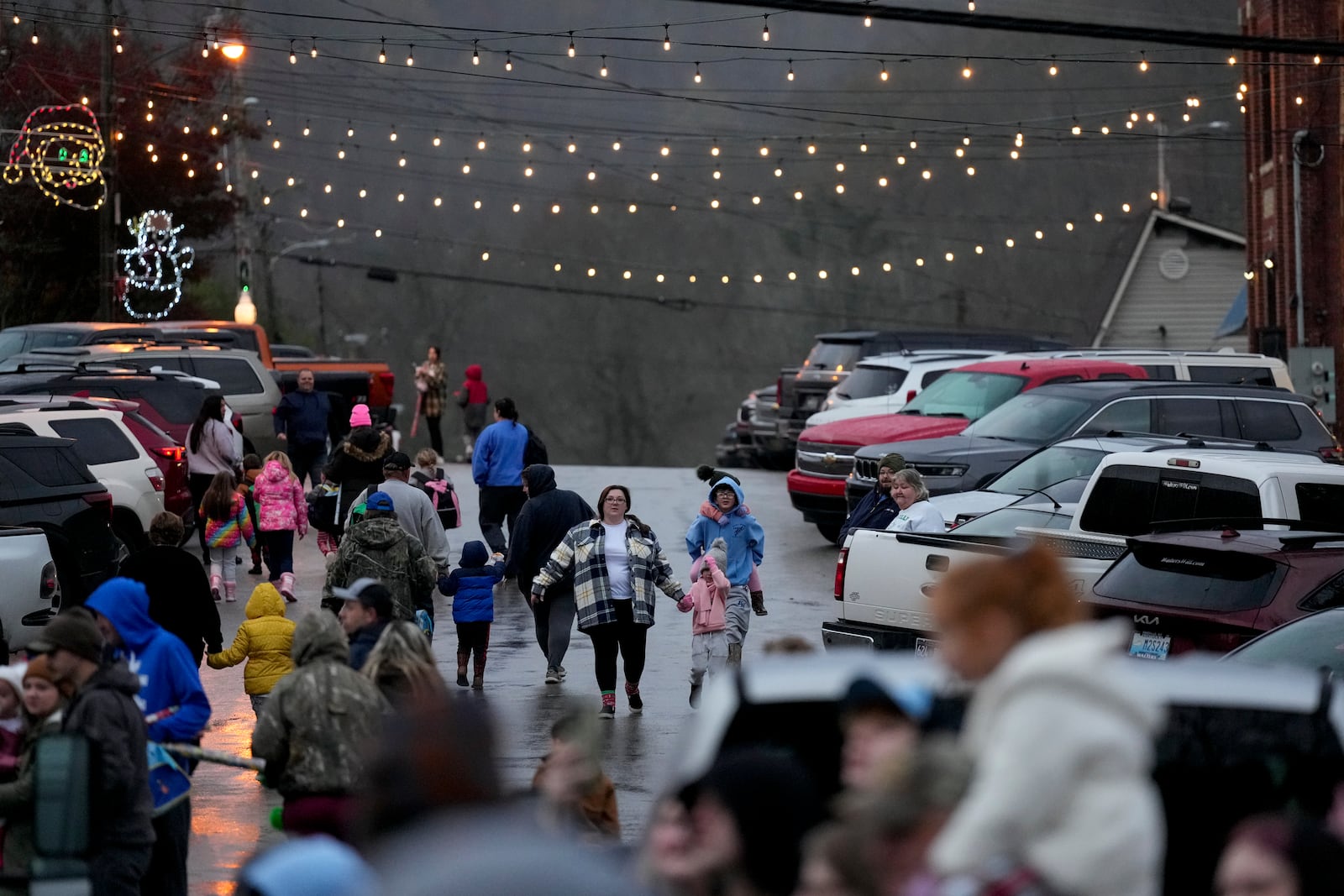 People make their way to the CSX Santa Train, Saturday, Nov. 23, 2024, in Elkhorn City, Ky. (AP Photo/George Walker IV)