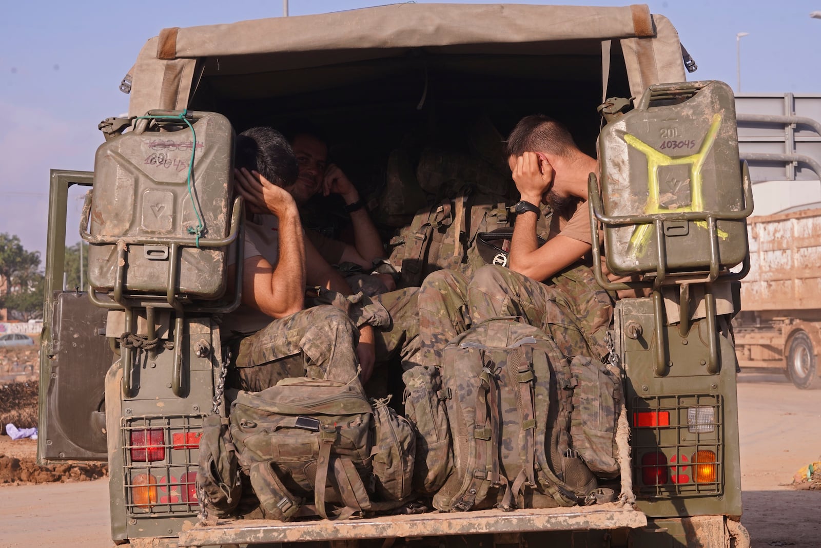 Soldiers helping with the floods get some rest inside an army vehicle in Alfafar on the outskirts of Valencia, Spain, Wednesday, Nov. 6, 2024. (AP Photo/Alberto Saiz)