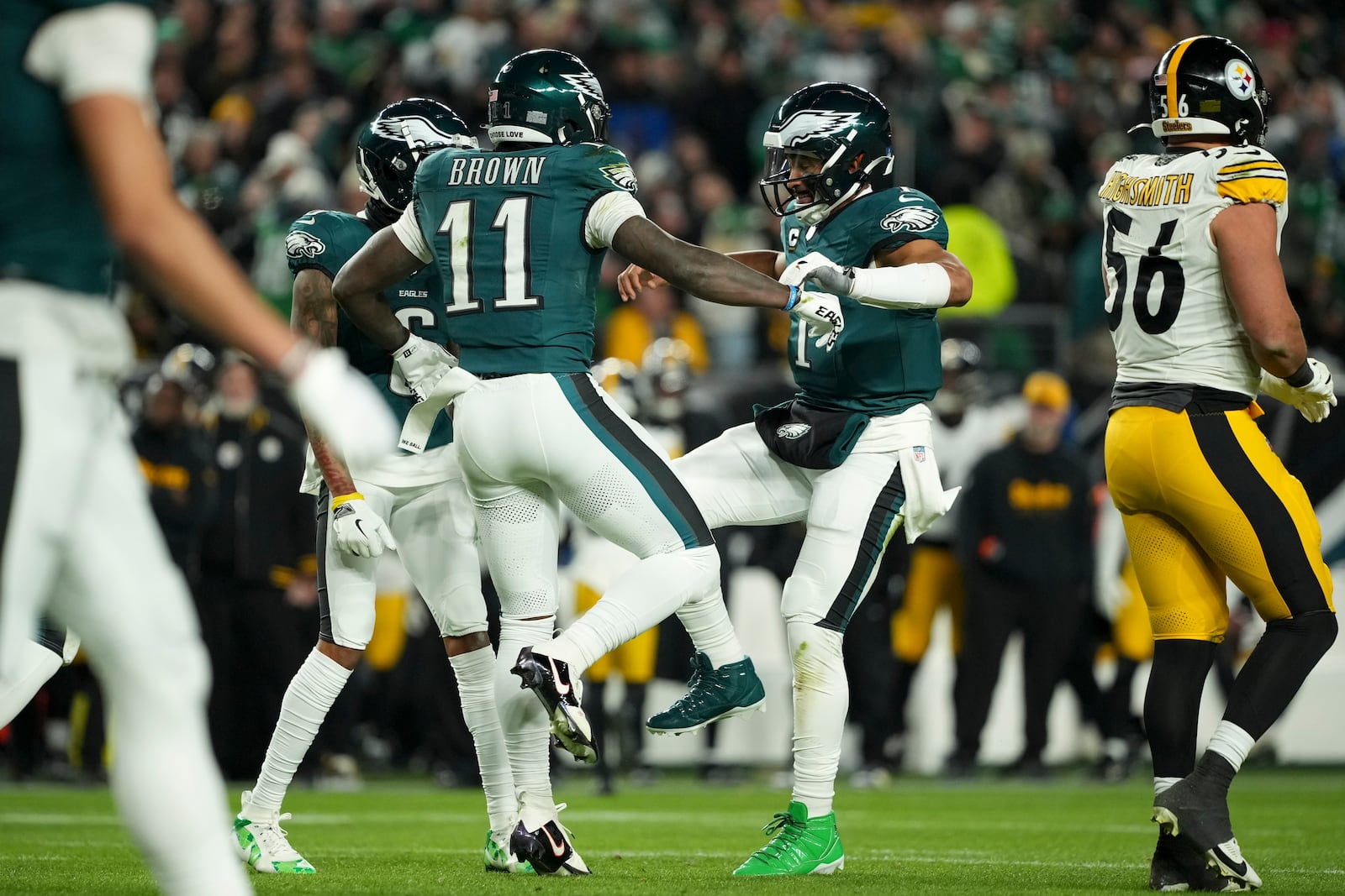 Philadelphia Eagles wide receiver A.J. Brown (11) celebrates his touchdown with teammates Jalen Hurts (1) and DeVonta Smith during the first half of an NFL football game against the Pittsburgh Steelers on Sunday, Dec. 15, 2024, in Philadelphia. (AP Photo/Matt Slocum)