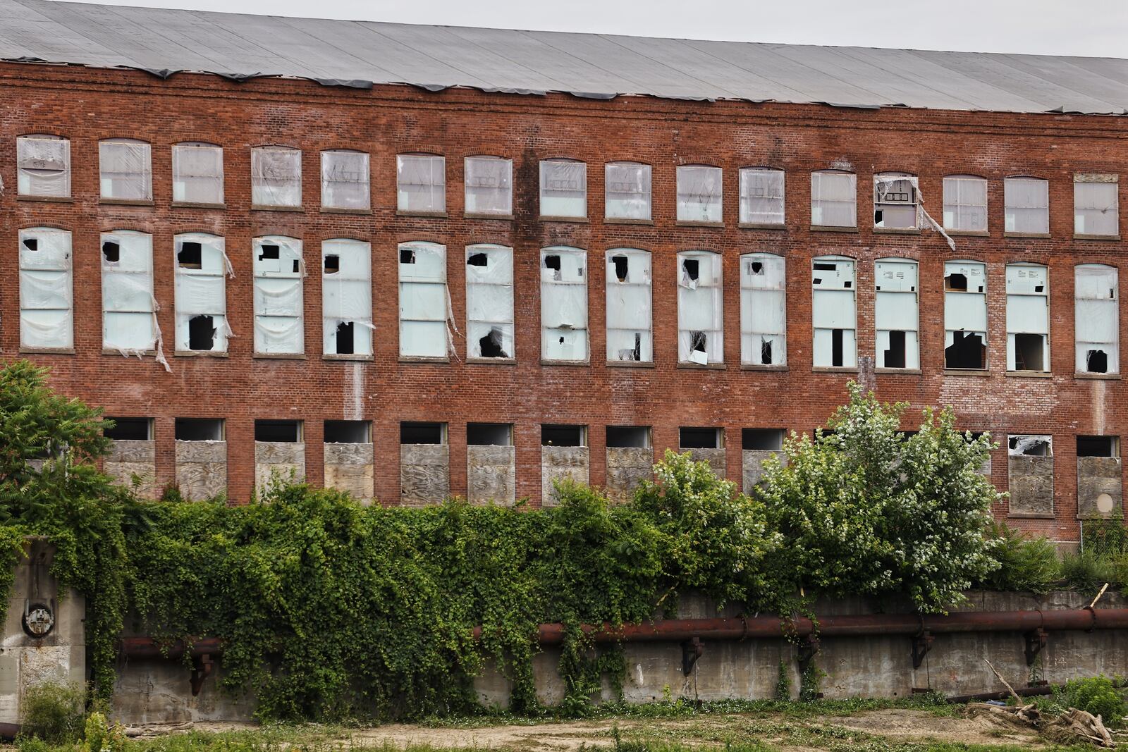 Historic-replica windows soon will begin filling in spaces in the massive walls of the former Champion Paper mill, being transformed into Spooky Nook Sports Champion Mill. Nick Graham/STAFF