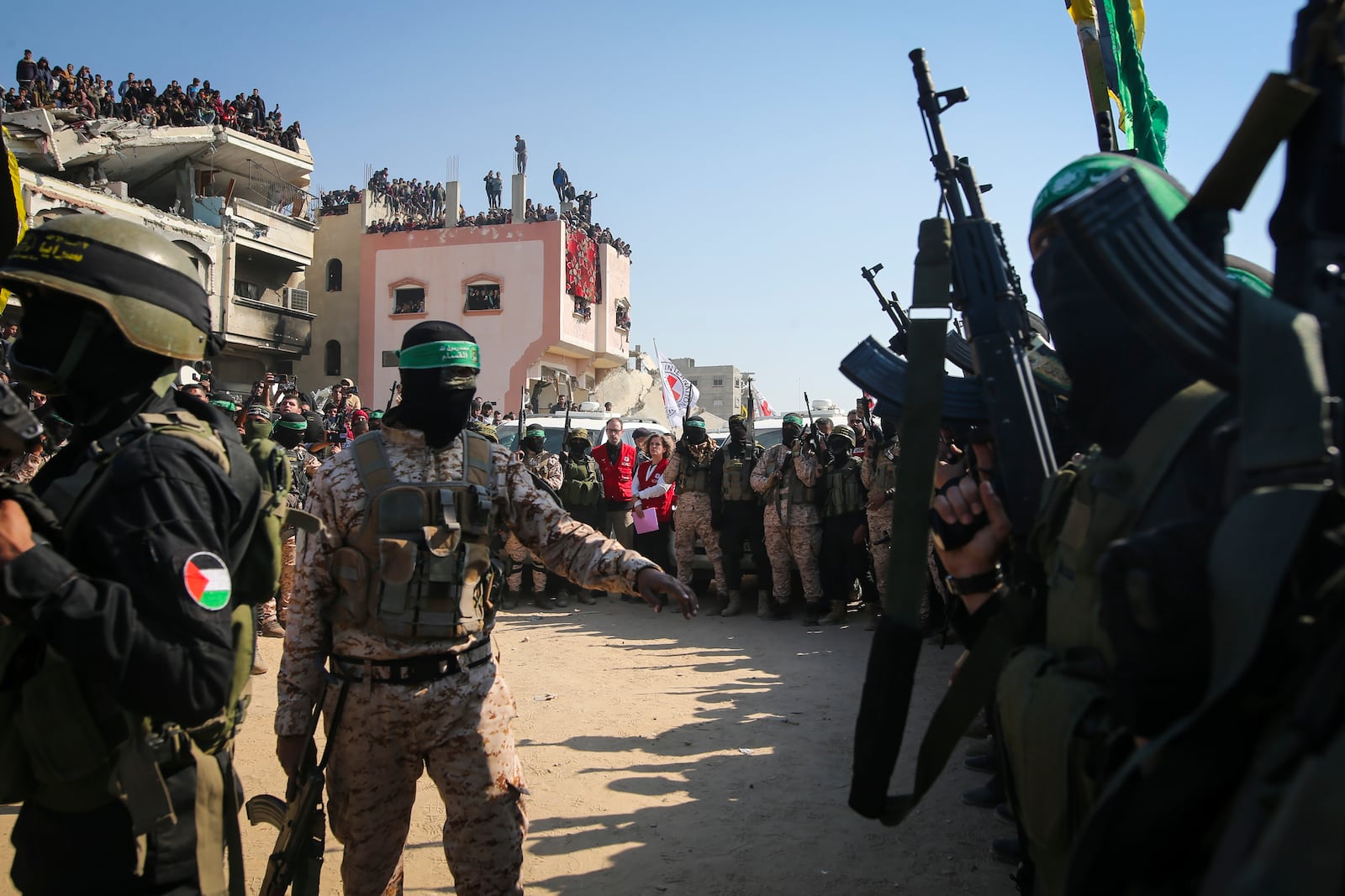 Hamas and Islamic Jihad militants secure the area as Red Cross representatives wait for the handover of Thai and Israeli hostages in Khan Younis, southern Gaza Strip, Thursday Jan. 30, 2025.(AP Photo/Jehad Alshrafi)